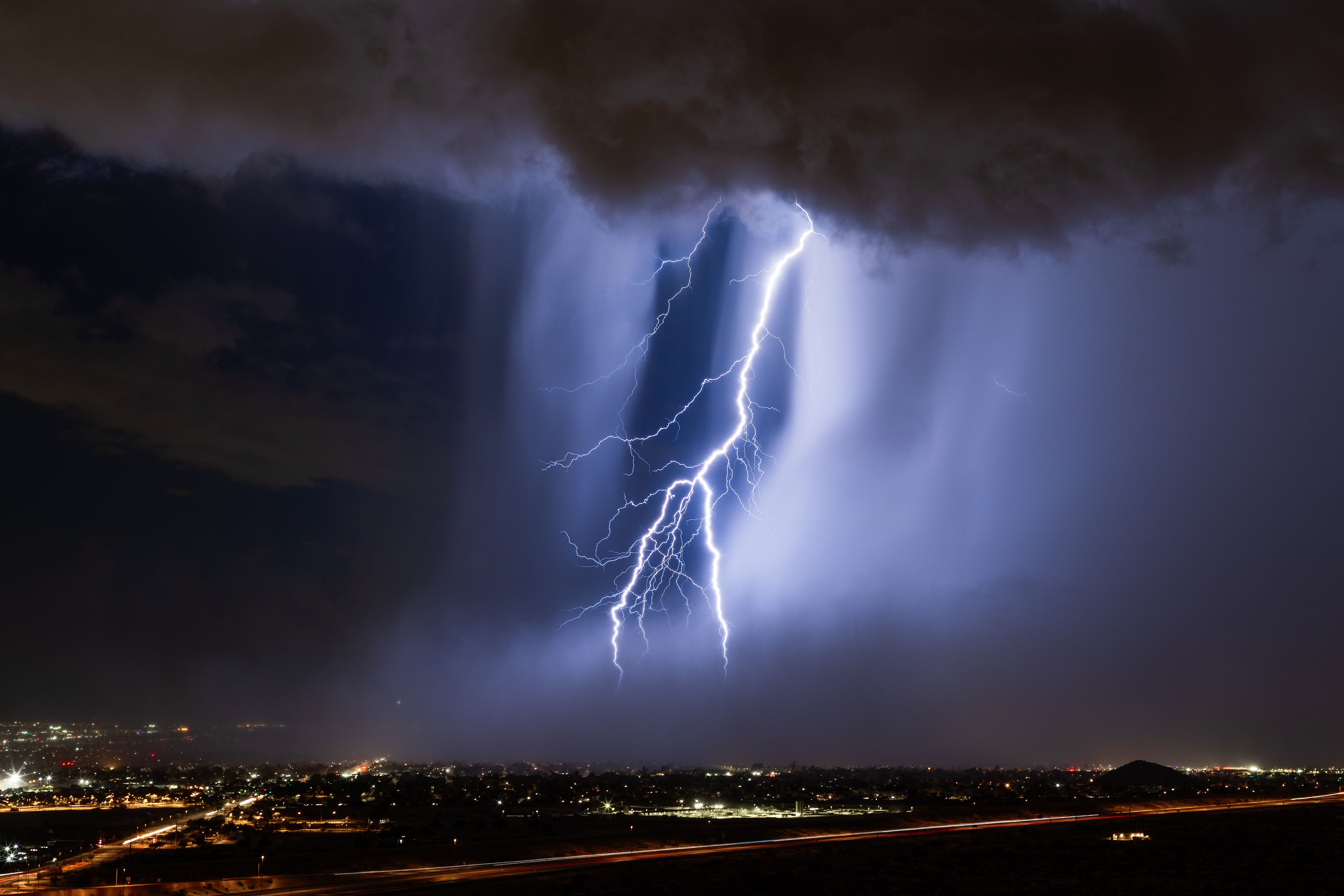 Lightning strikes through a microburst in a storm Lightning strikes through a microburst in a storm