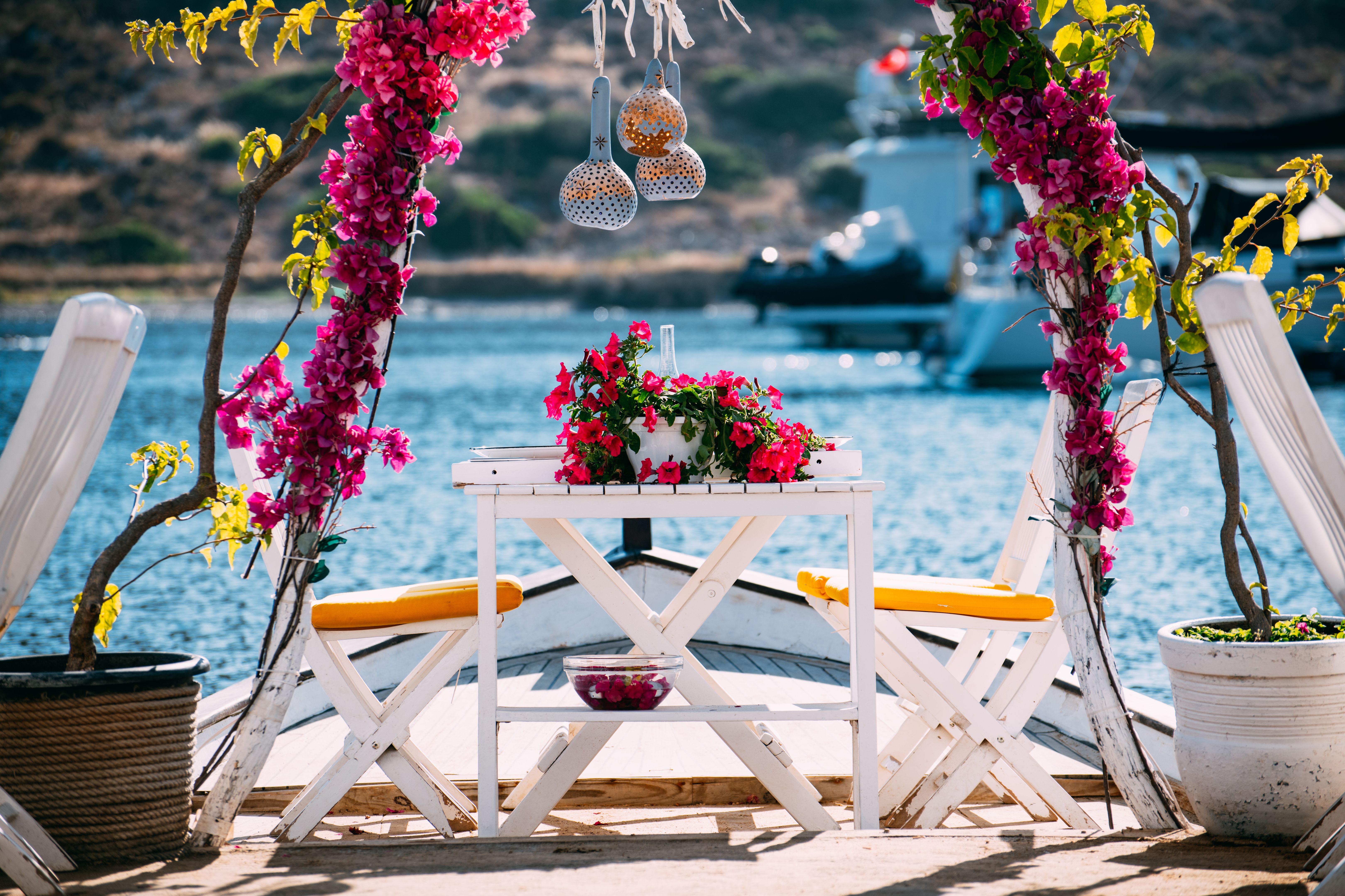 Dining Table Decorated With Flowers by the Sea Dining Table Decorated With Flowers by the Sea