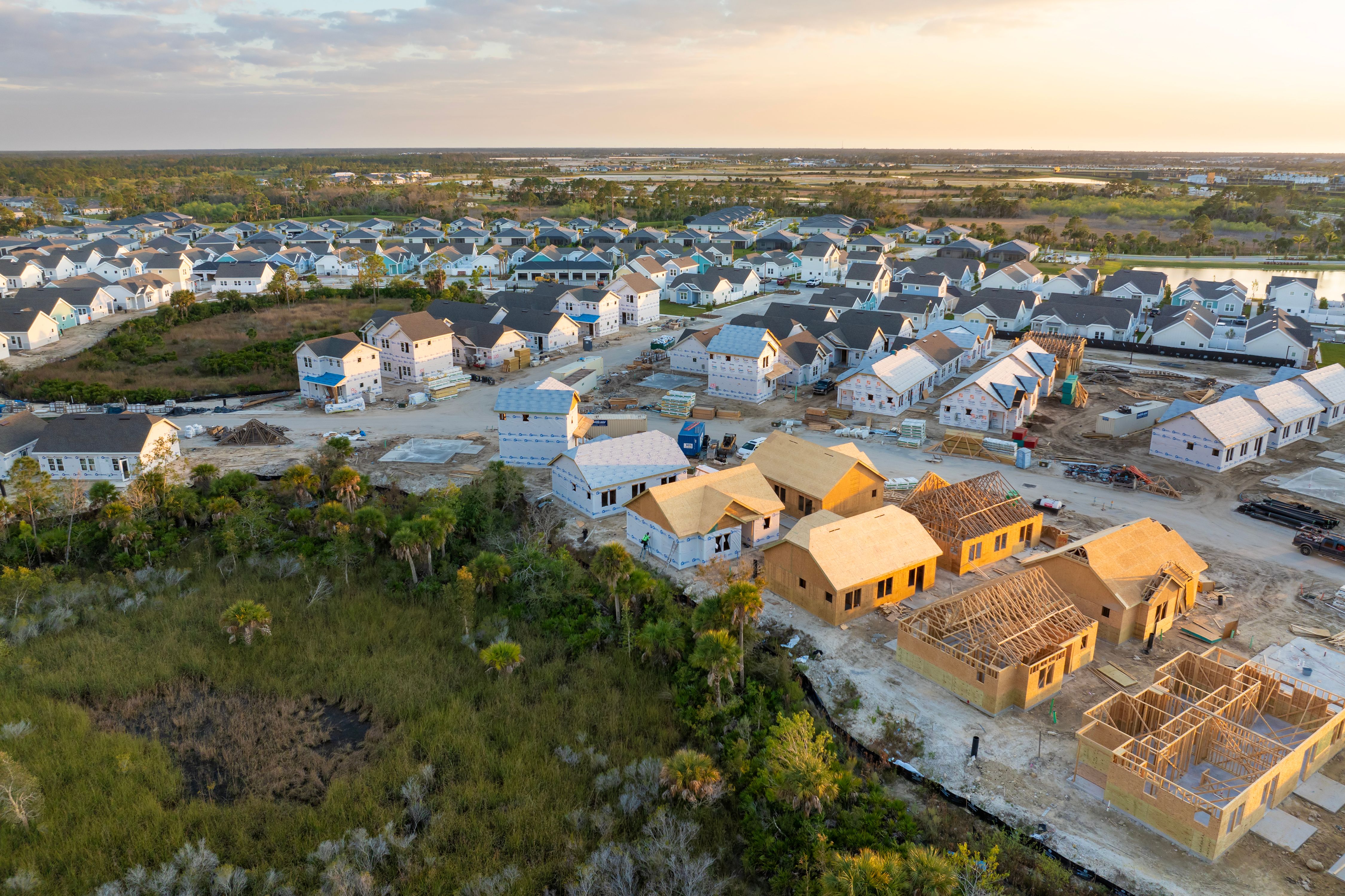 Wooden houses under construction in new developing suburban area. Development of residential housing in American suburbs. Real estate market in the USA