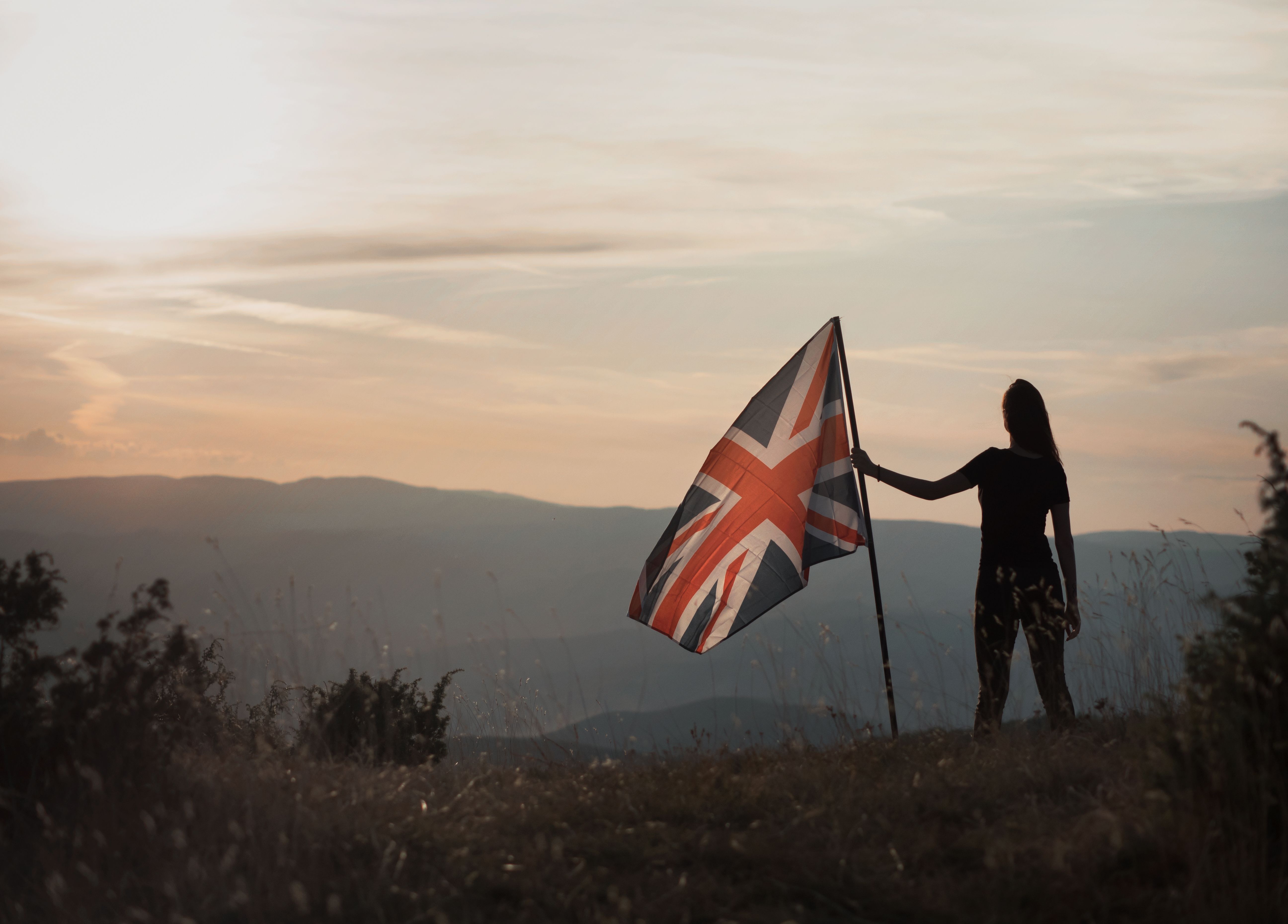 Proud woman holding the Great Britain flag Proud woman holding the Great Britain flag