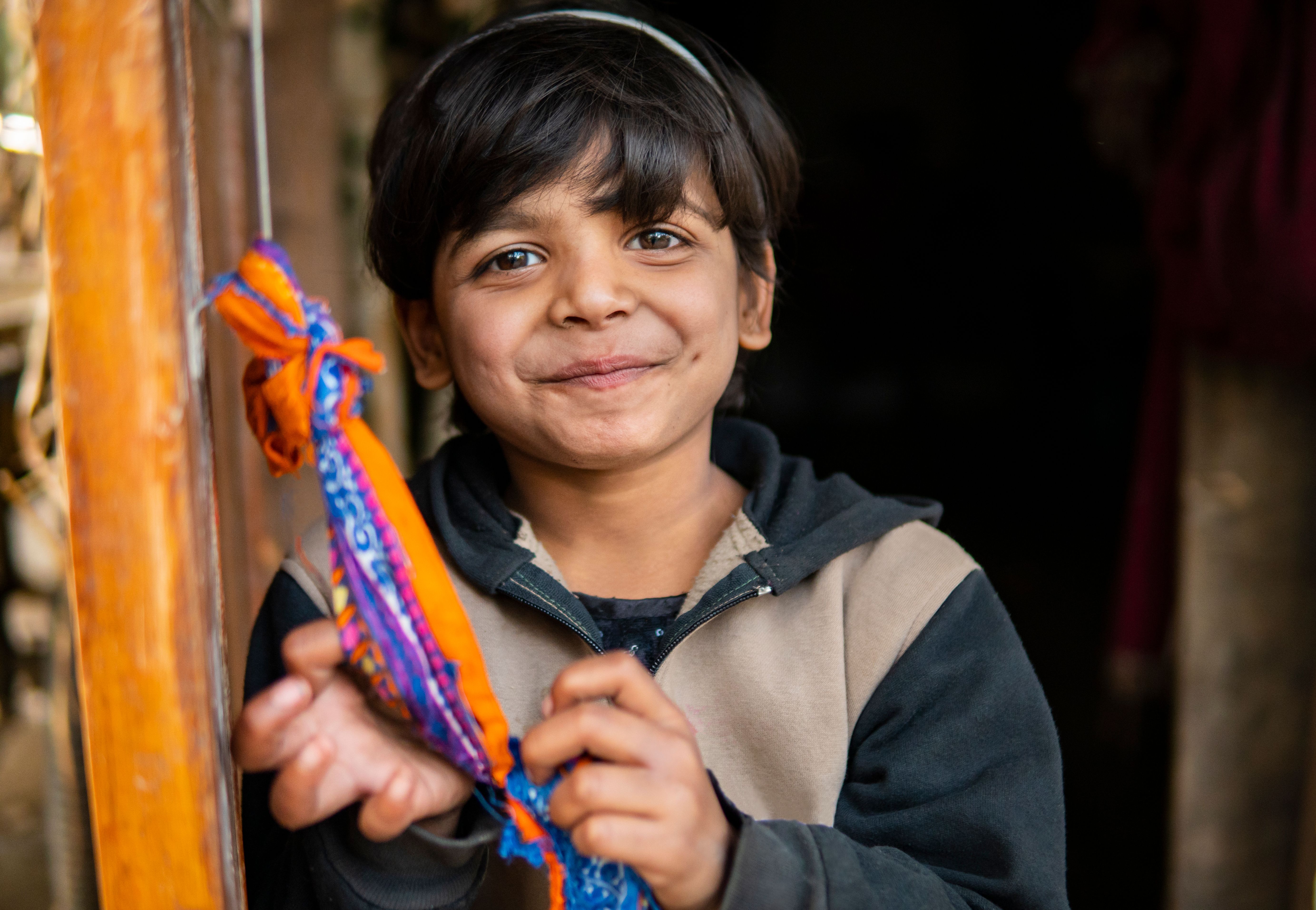 happy rural Indian girl standing near door and smile at the camera.
