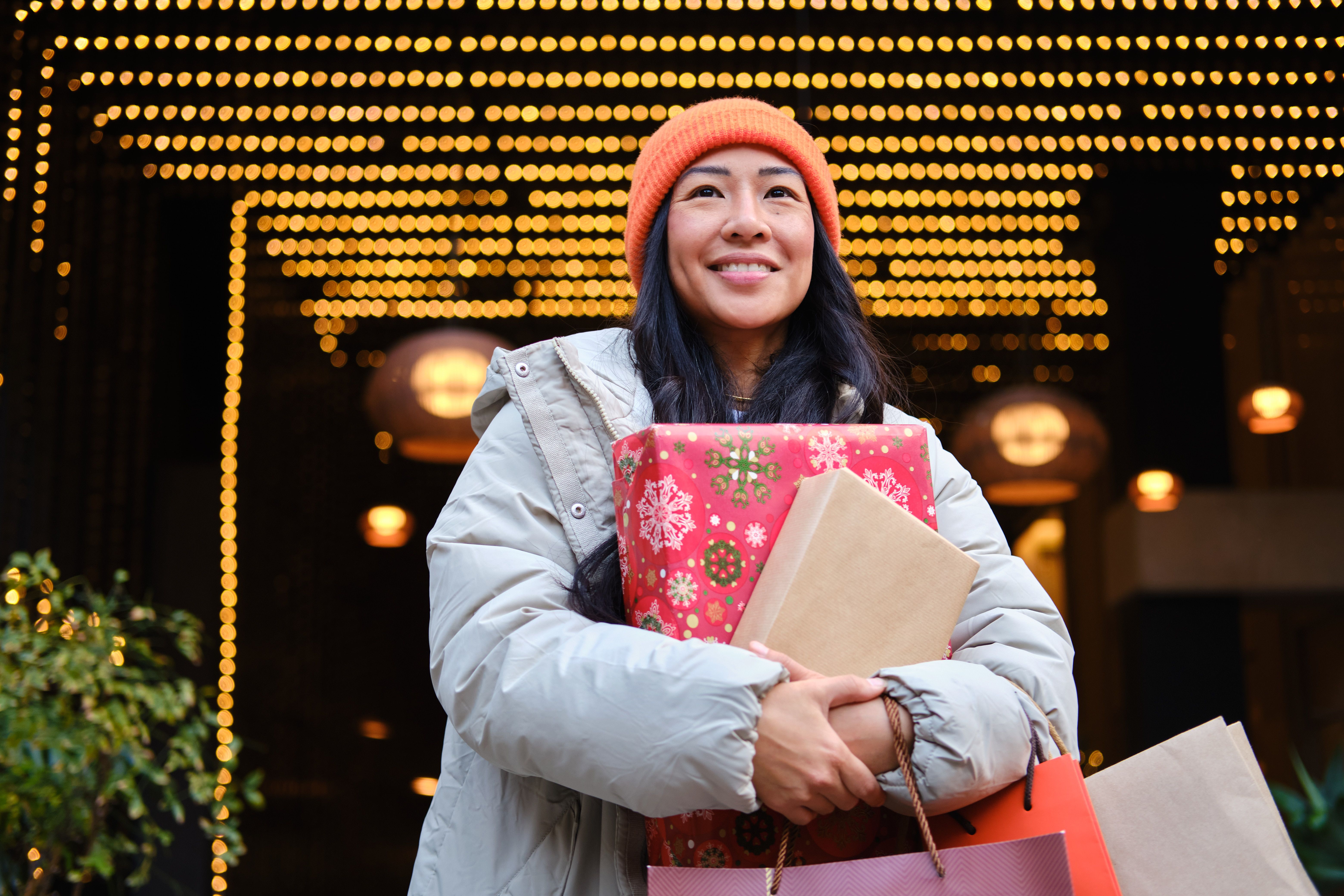 happy Young asian woman holding christmas gifts in Barcelona city center happy Young asian woman holding christmas gifts in Barcelona city center