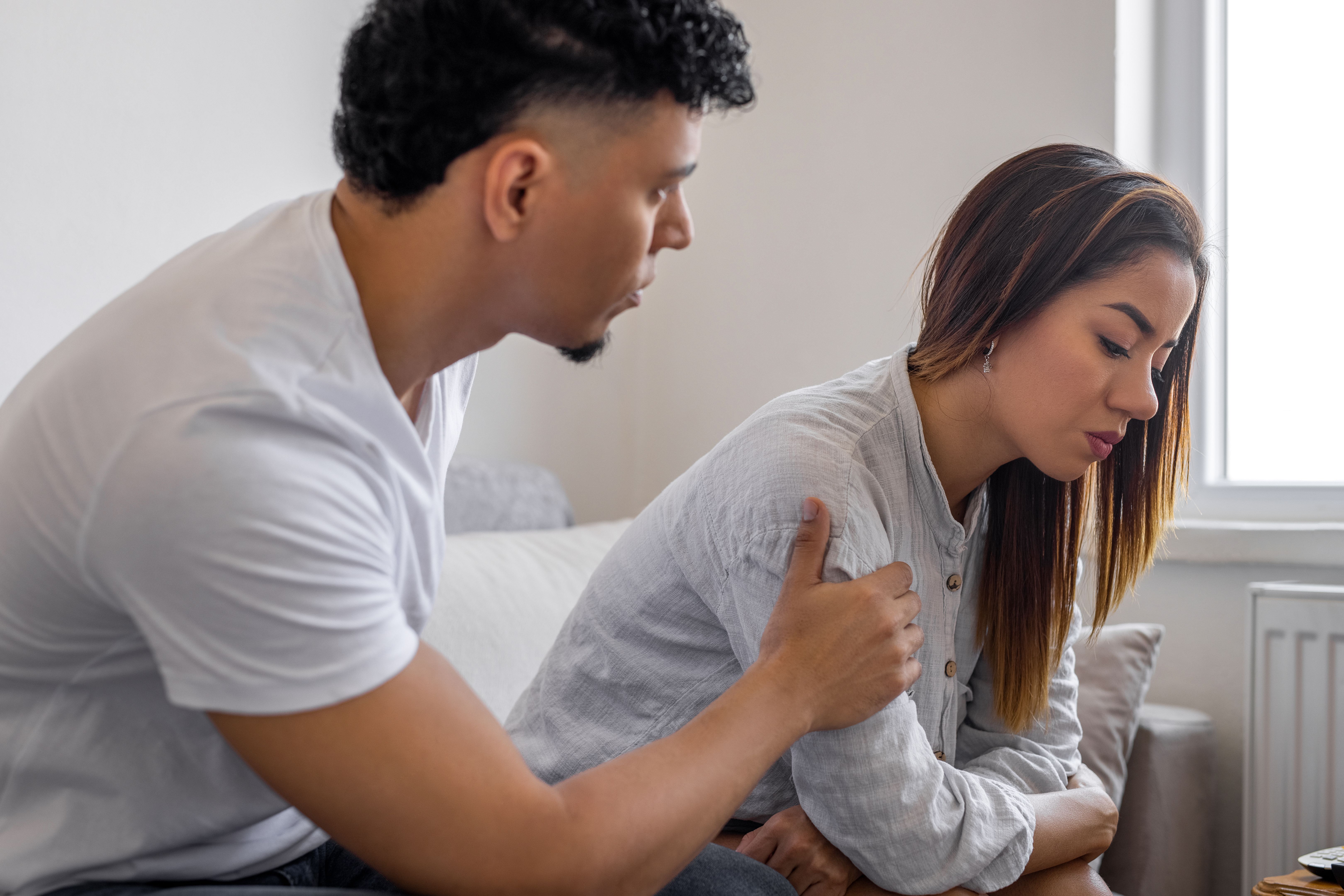 Man comforting his wife at home