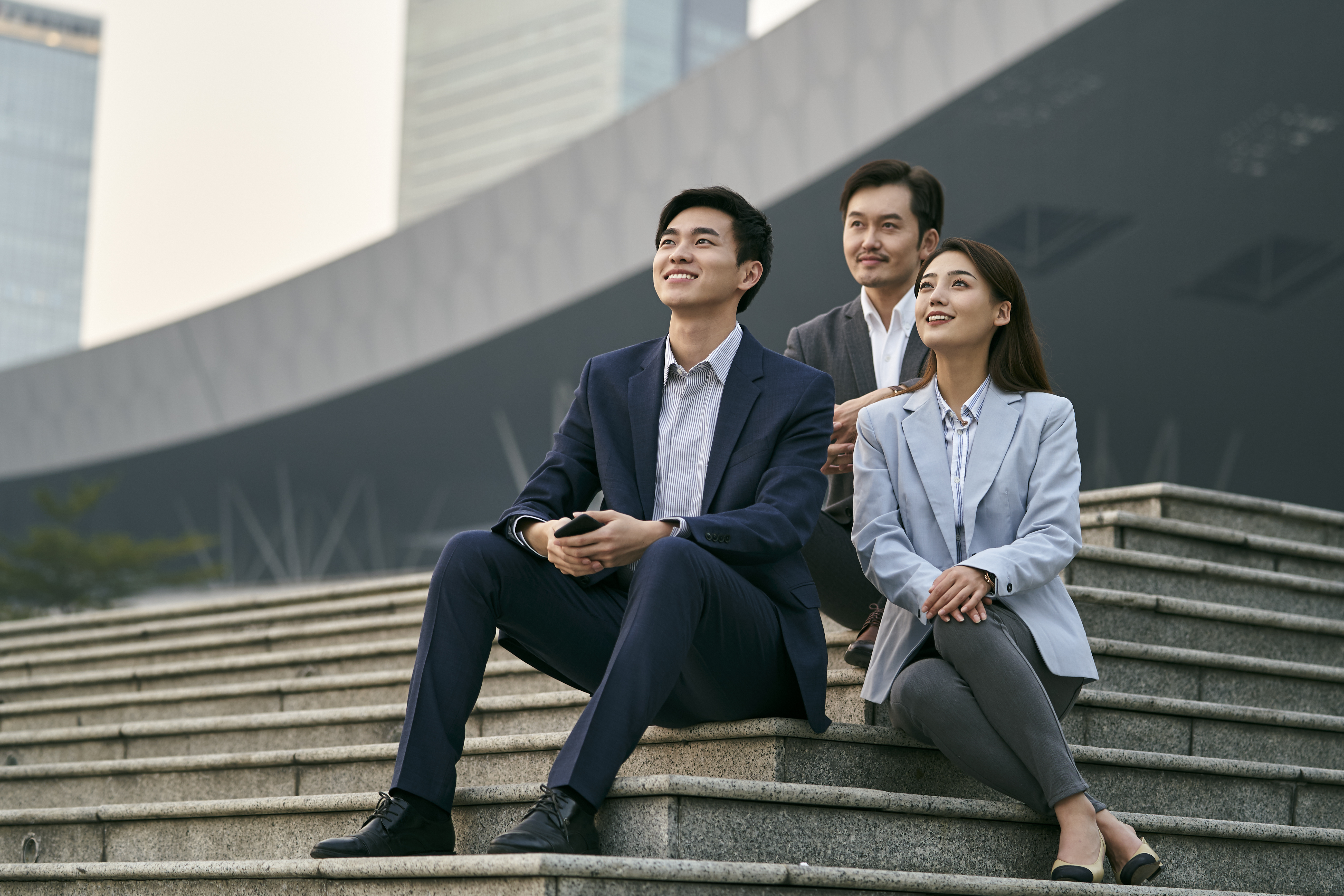 asian business people relaxing outdoors