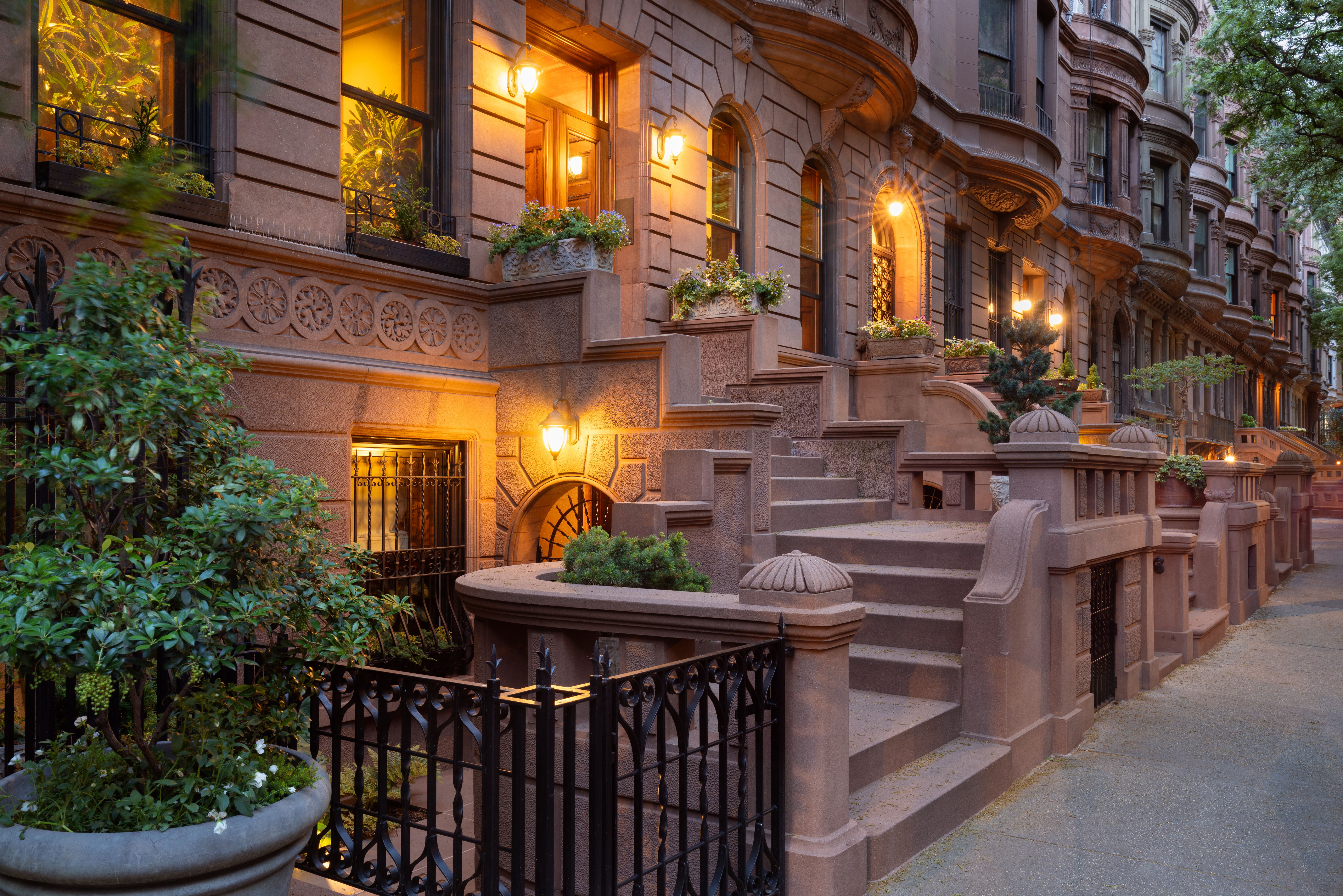 Evening view of iconic New York City brownstones with stoop steps on Upper West Side of Manhattan. This row of brownstones is located in Central Park West Historic District