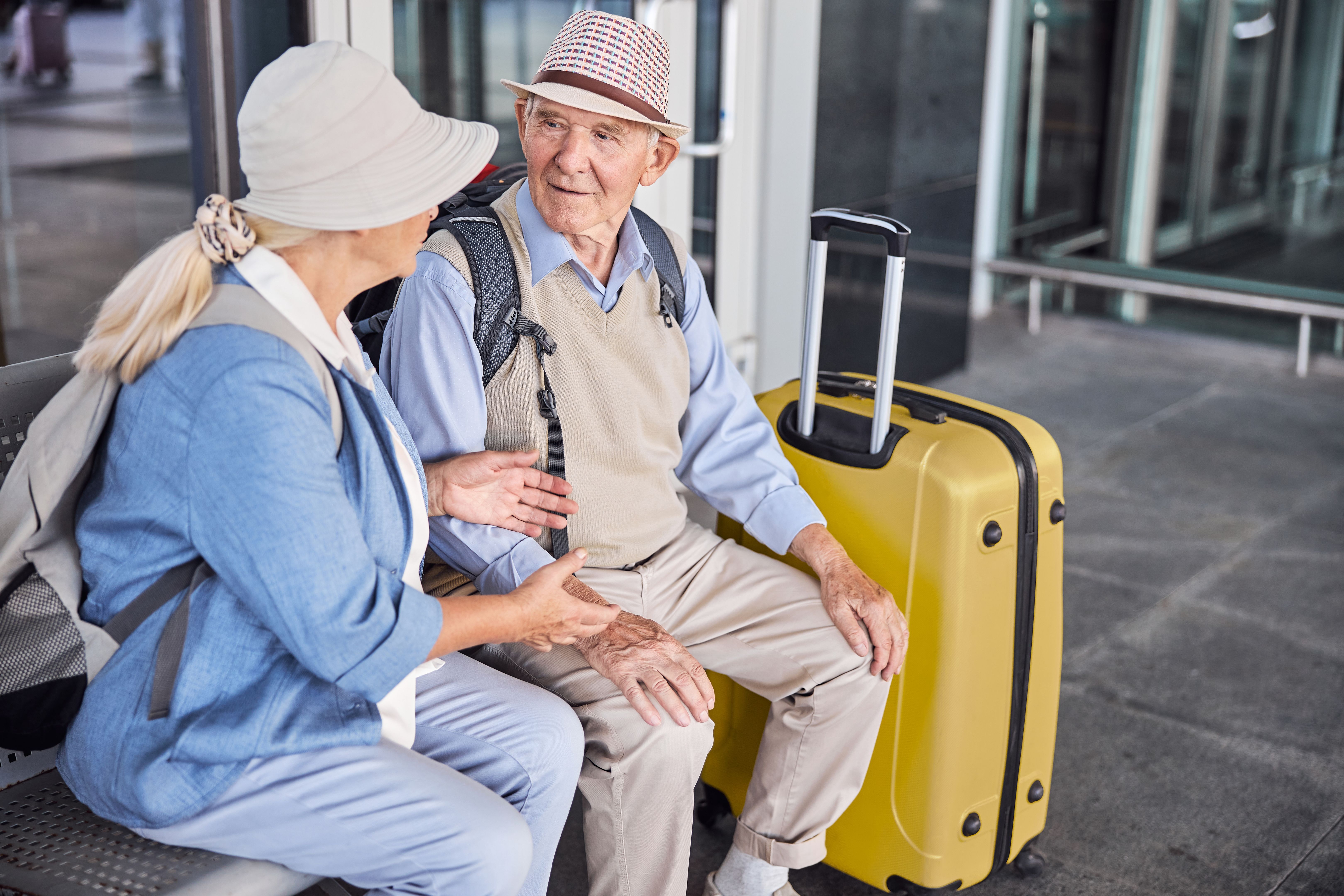 Two senior people having a conversation on the bench