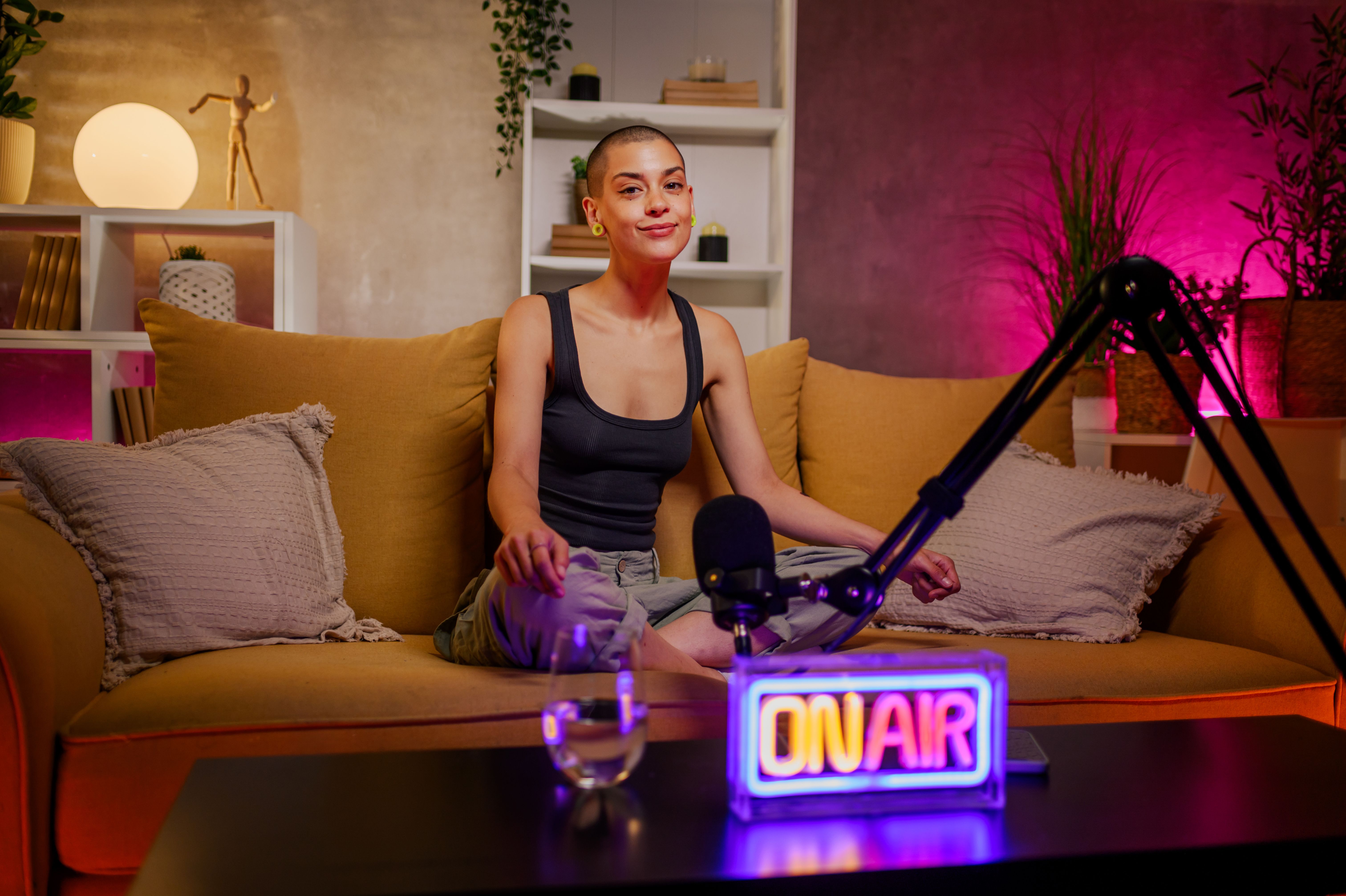 Caucasian bald woman radio host recording podcast in a cozy studio Caucasian bald woman radio host recording podcast in a cozy studio