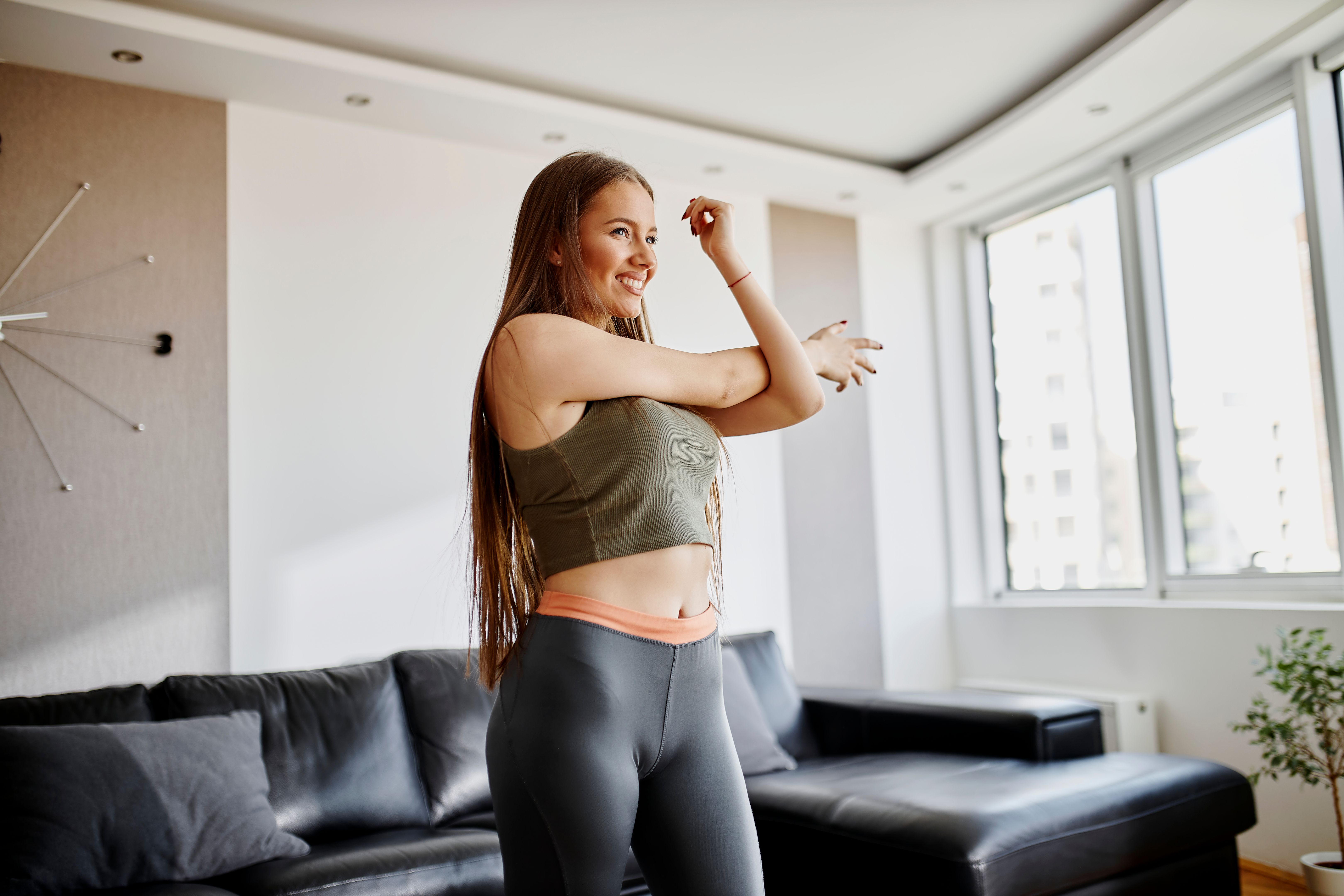 Young woman having home workout at her living room