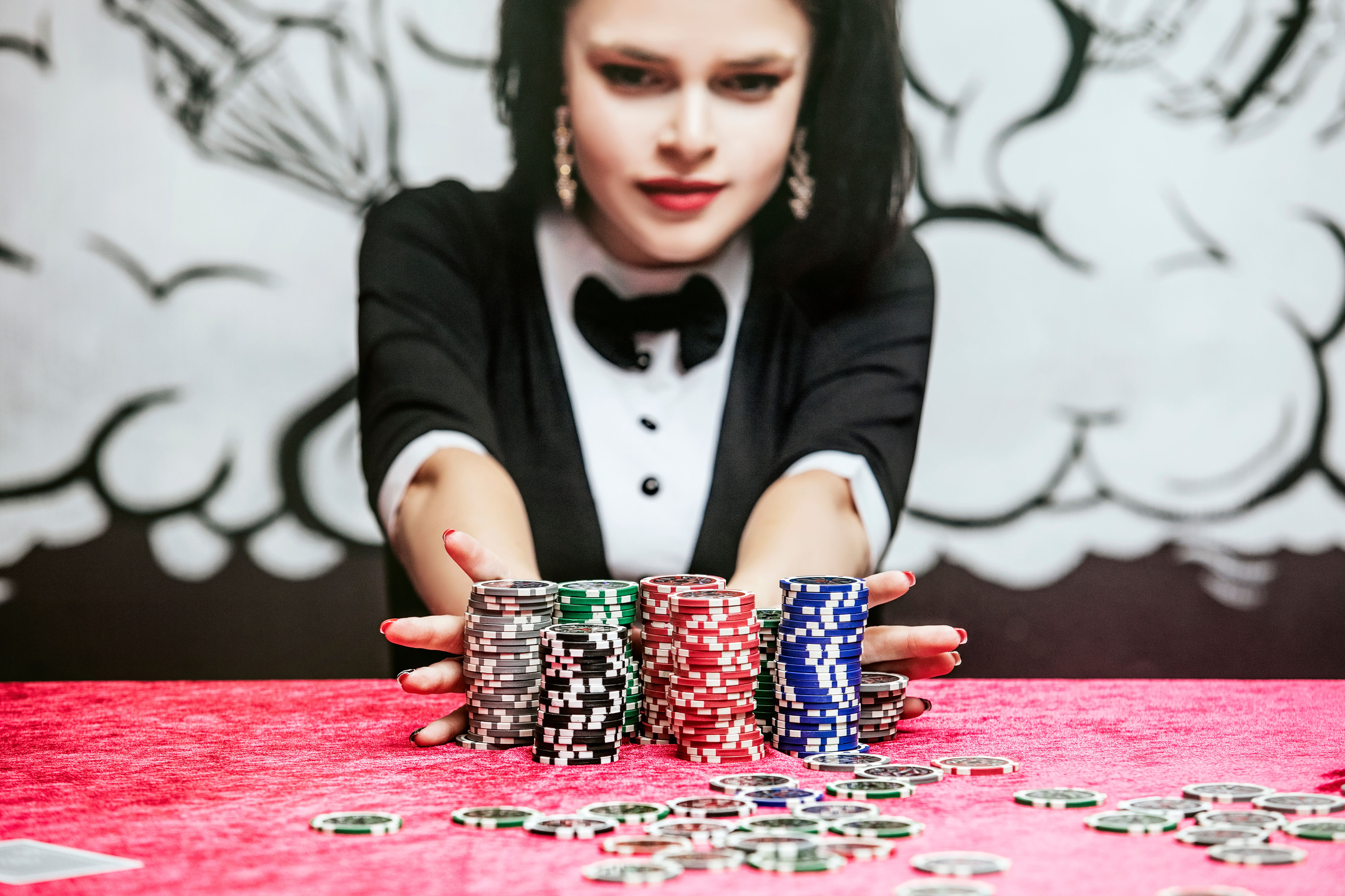 Woman beautiful young successful gambling in a casino at a table with cards, chips and alcohol closeup Woman beautiful young successful gambling in a casino at a table with cards, chips and alcohol closeup