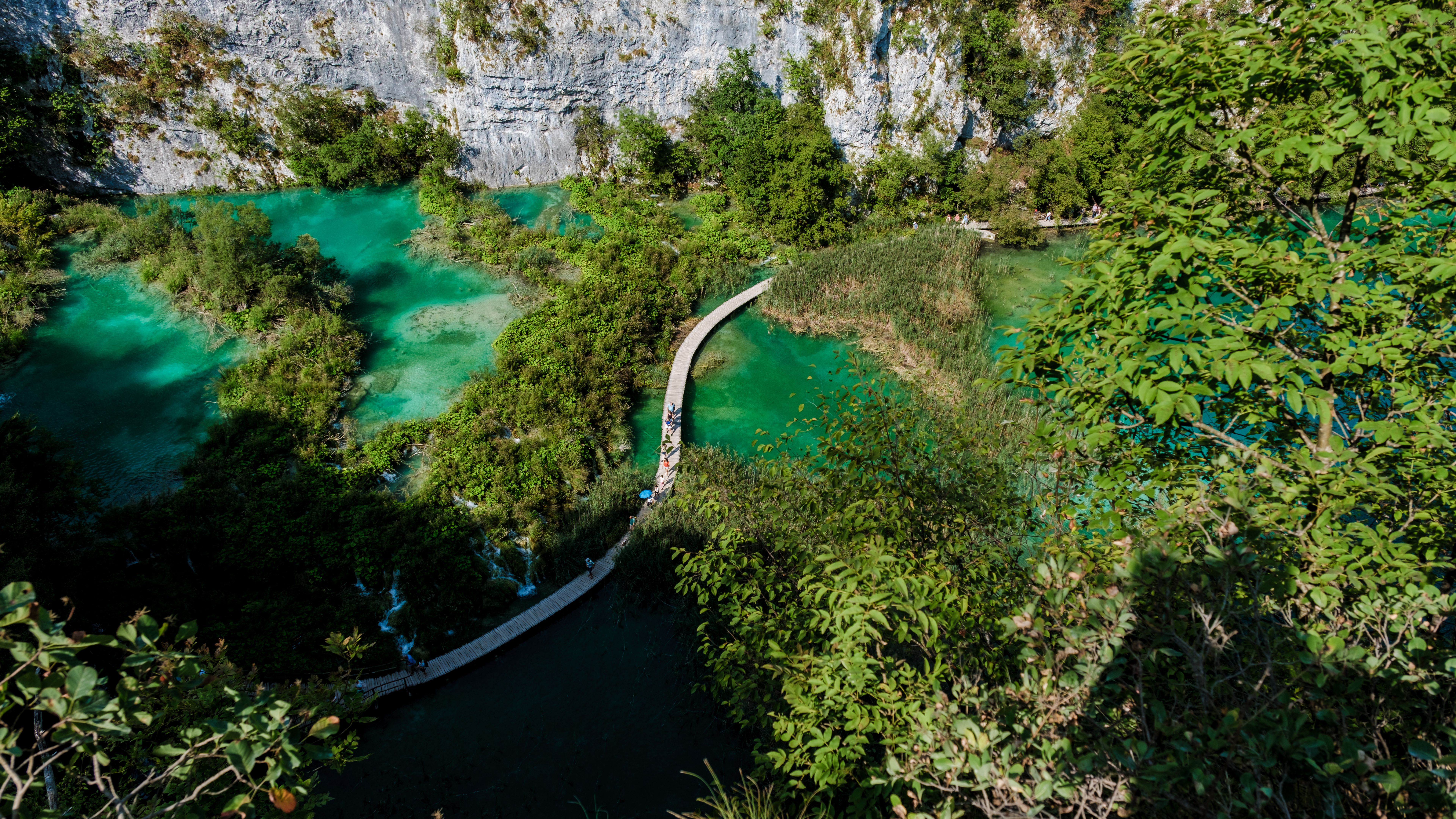 Explore the stunning Plitvice Lakes in Croatia with its bright turquoise waters and lush nature