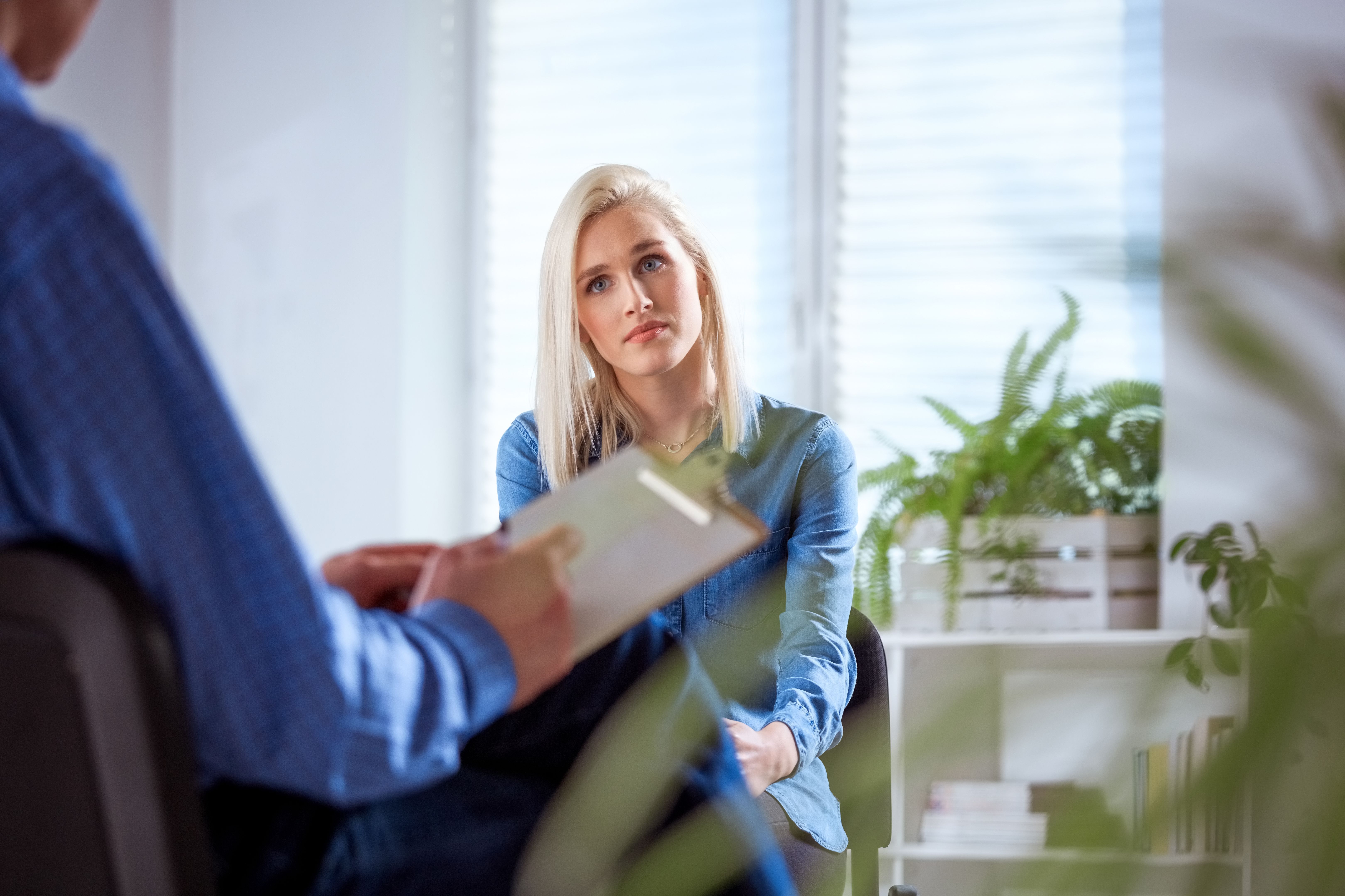 Female student listening to therapist in meeting Female student listening to therapist in meeting