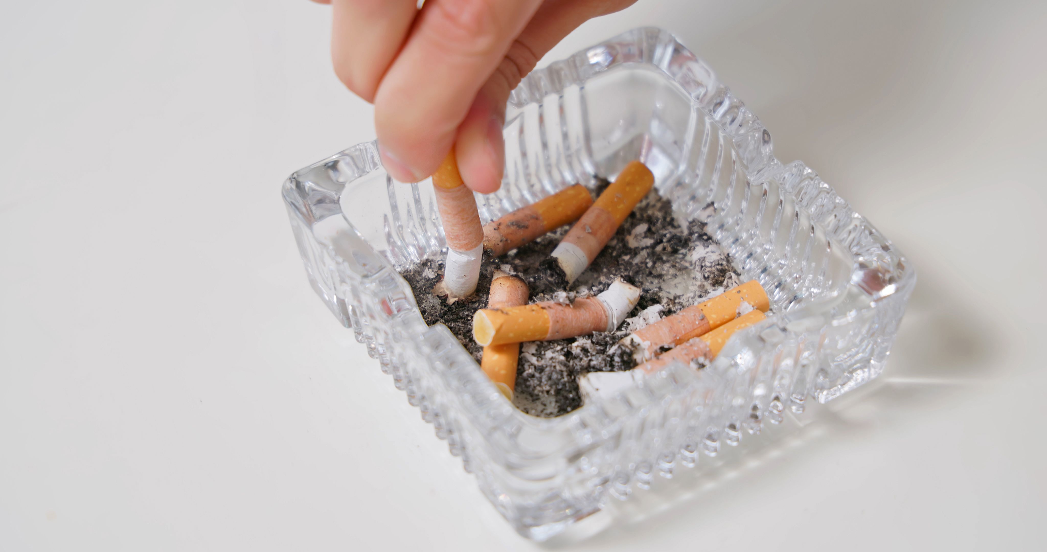 human hand put out cigarette