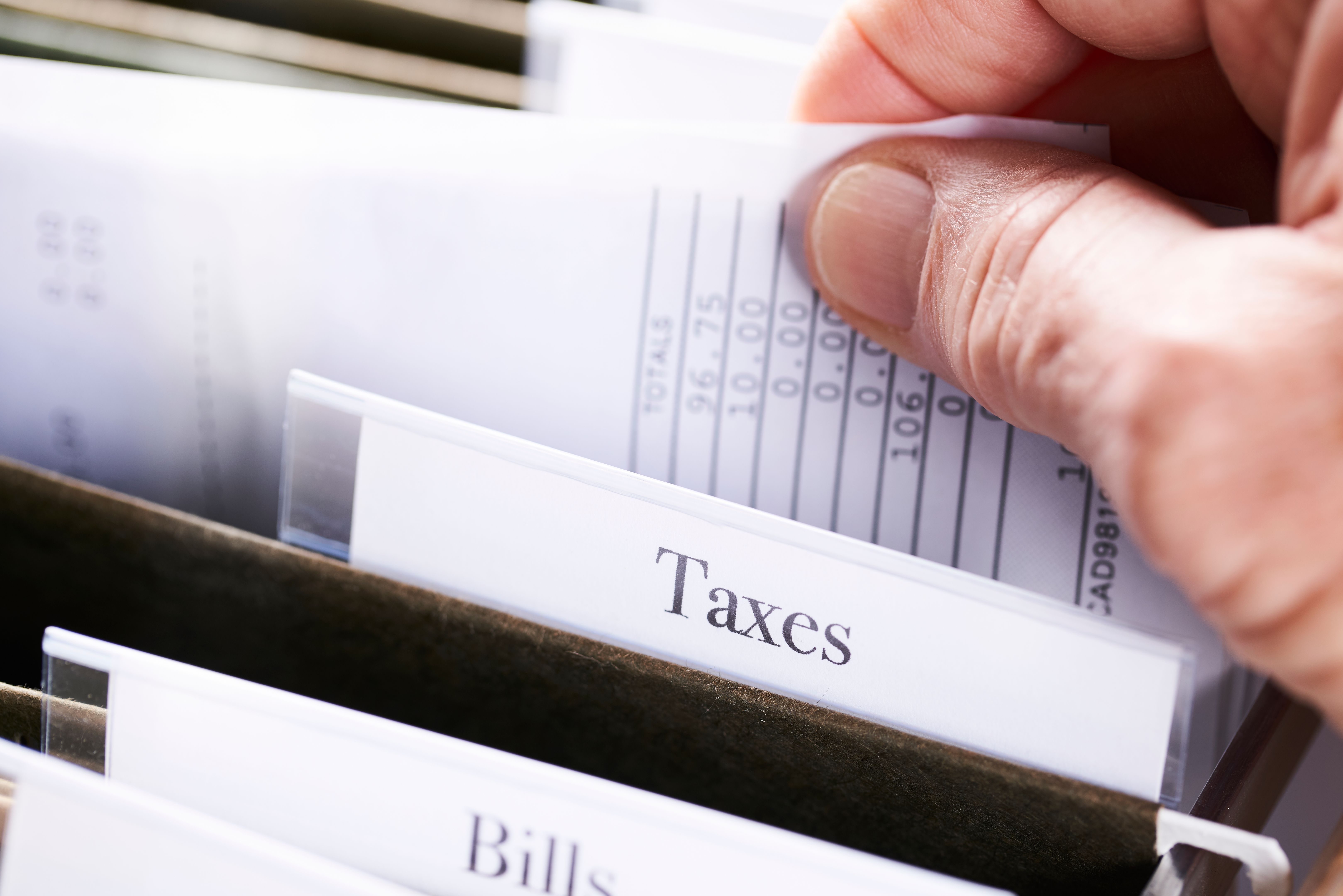 TAXES: Files and folders in desk drawer with labels and tabs: Home office management TAXES: Files and folders in desk drawer with labels and tabs: Home office management