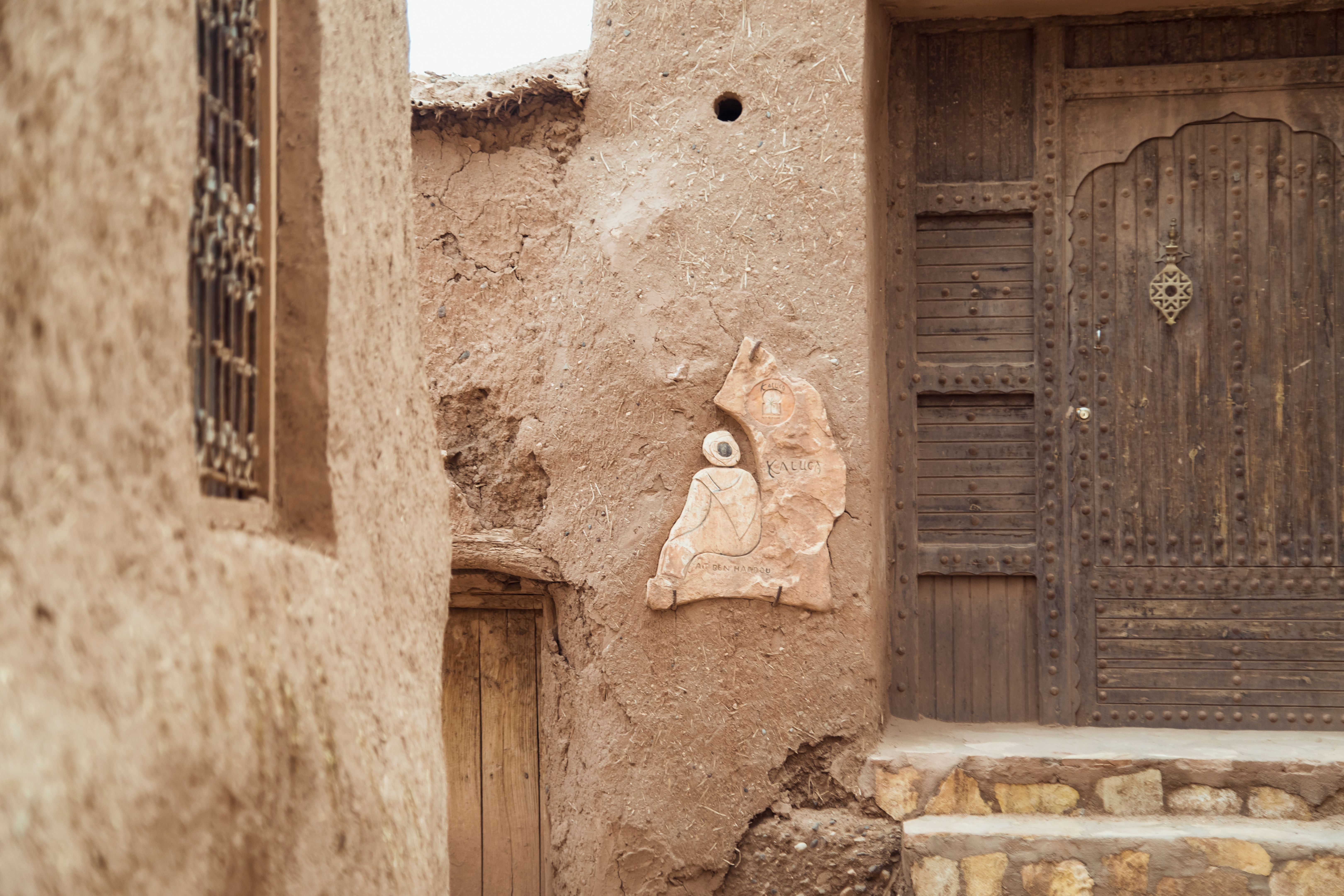 A Glimpse of Ancient Moroccan Architecture With Intricate Carvings and a Wooden Door in the Homeland
