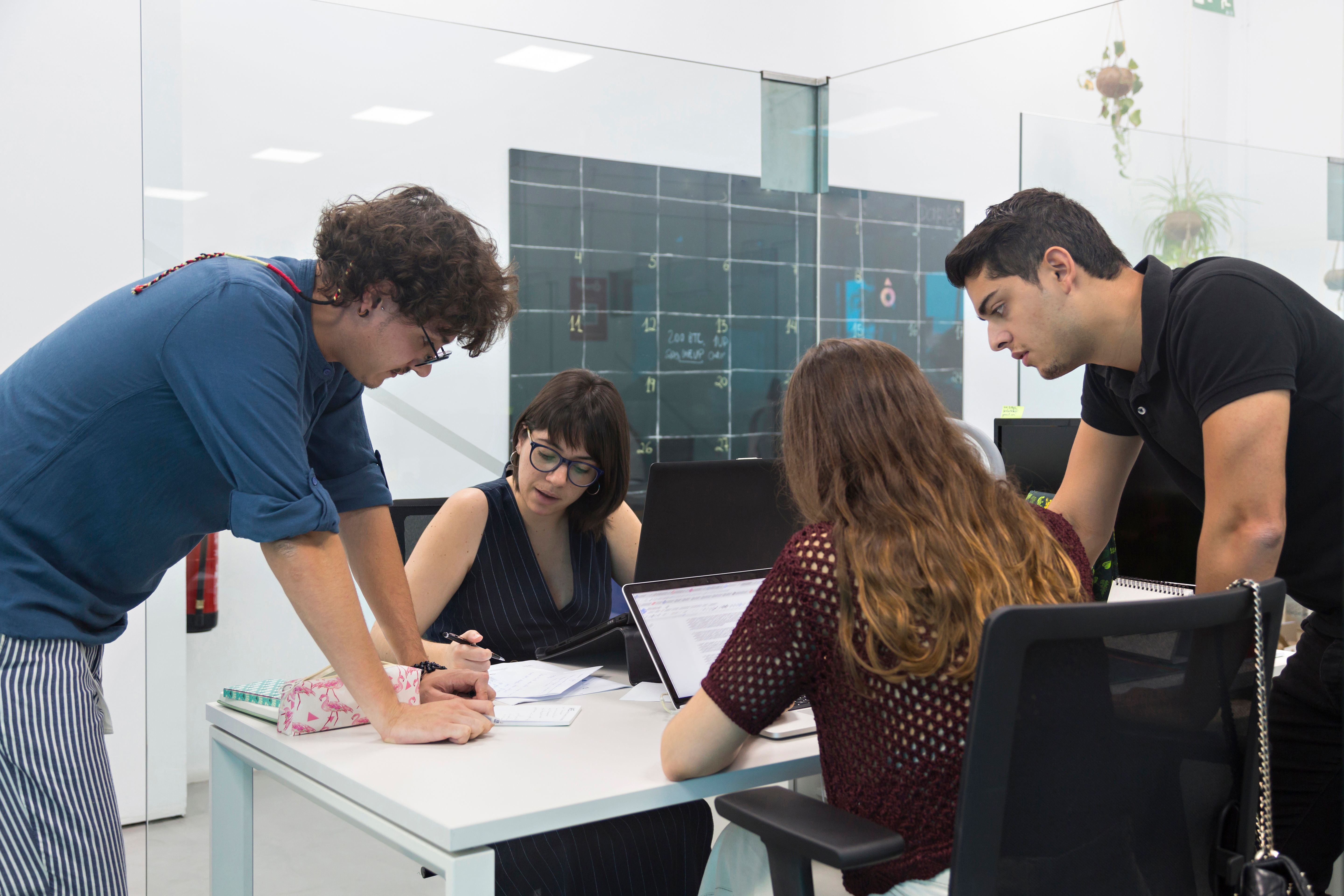 Young people gathered in a coworking discussing new marketing campaign. Young people gathered in a coworking discussing new marketing campaign.