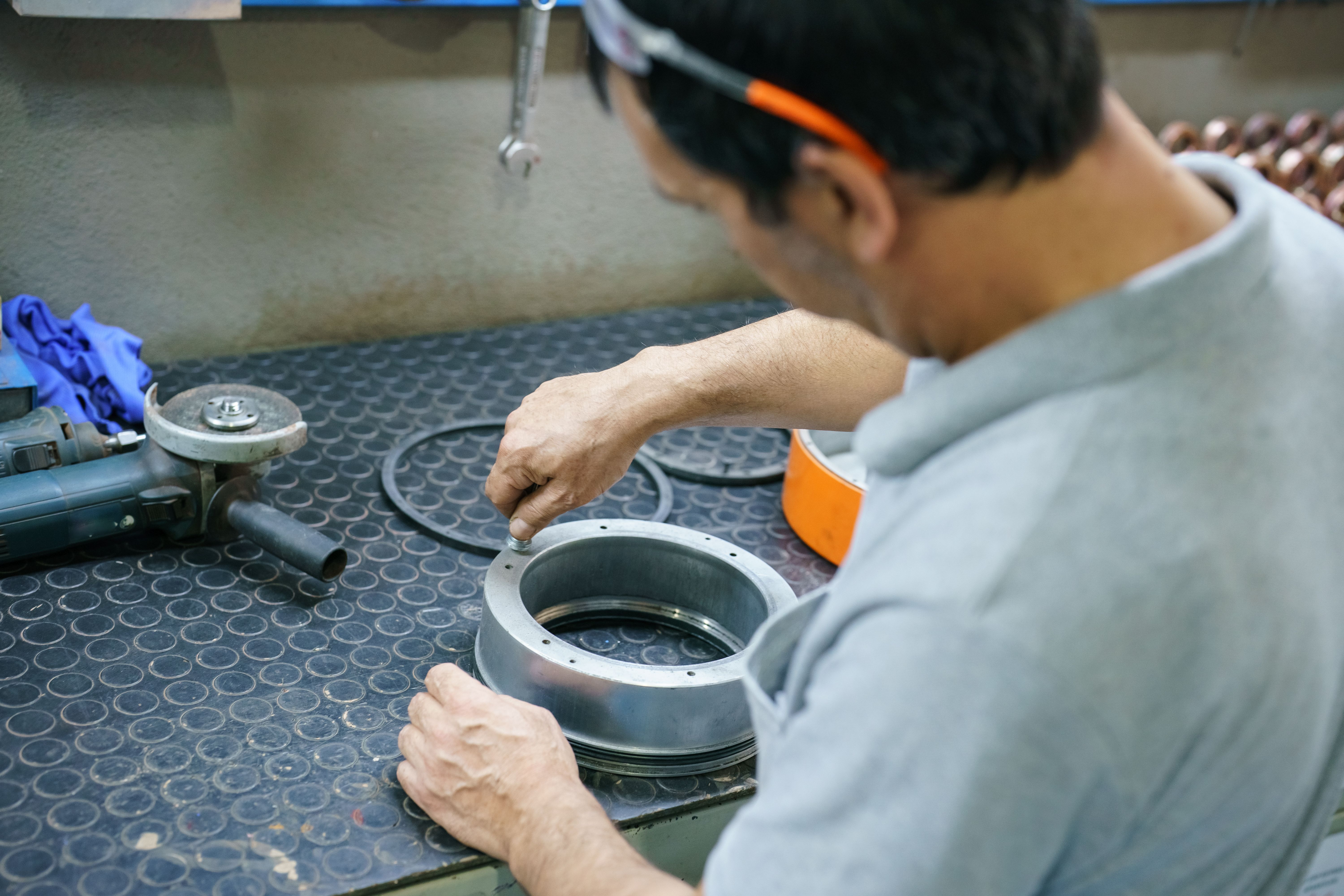Blue collar worker working at workbench with work tools