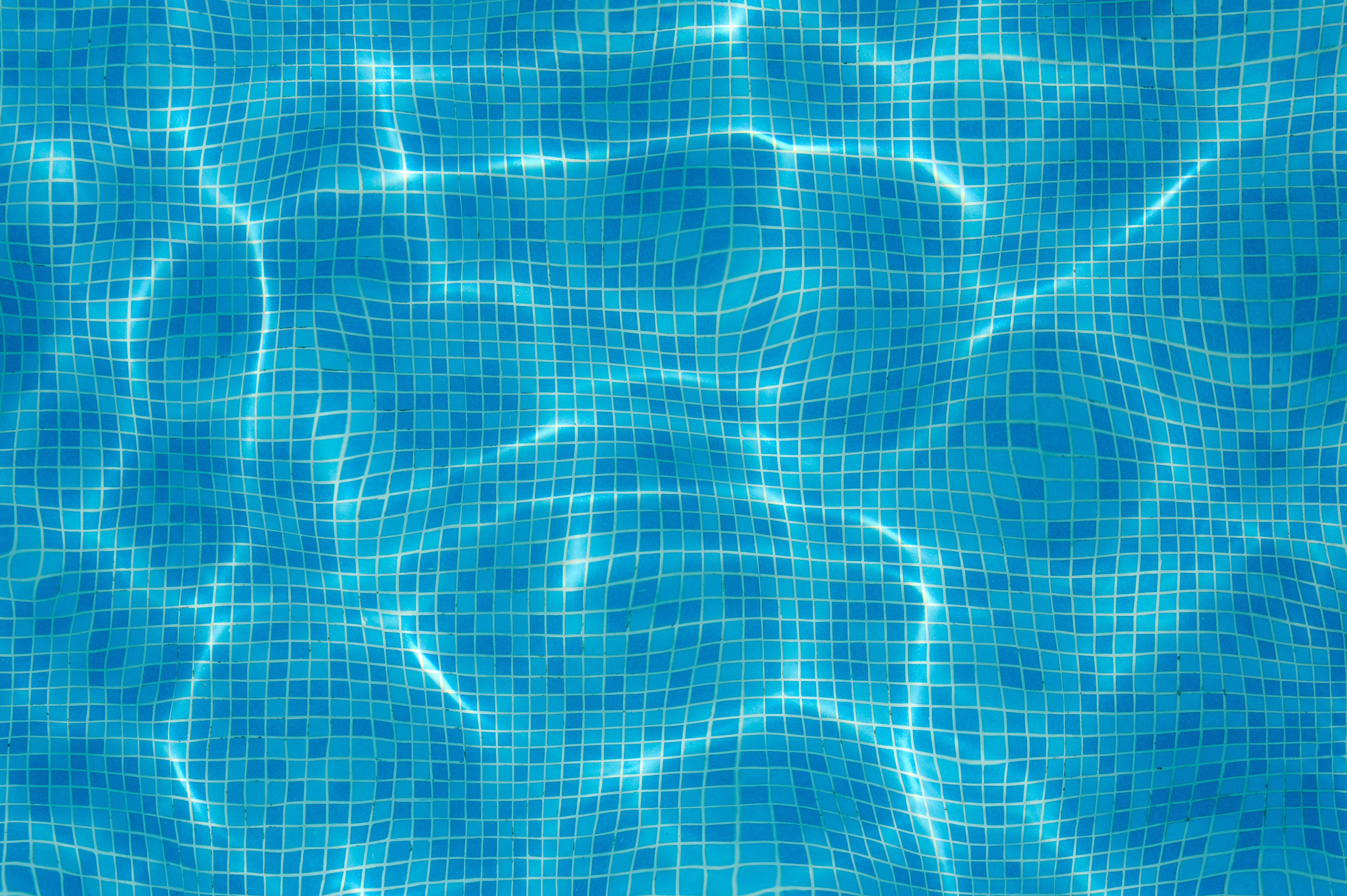 Blue water of the pool. Background. Selective focus.