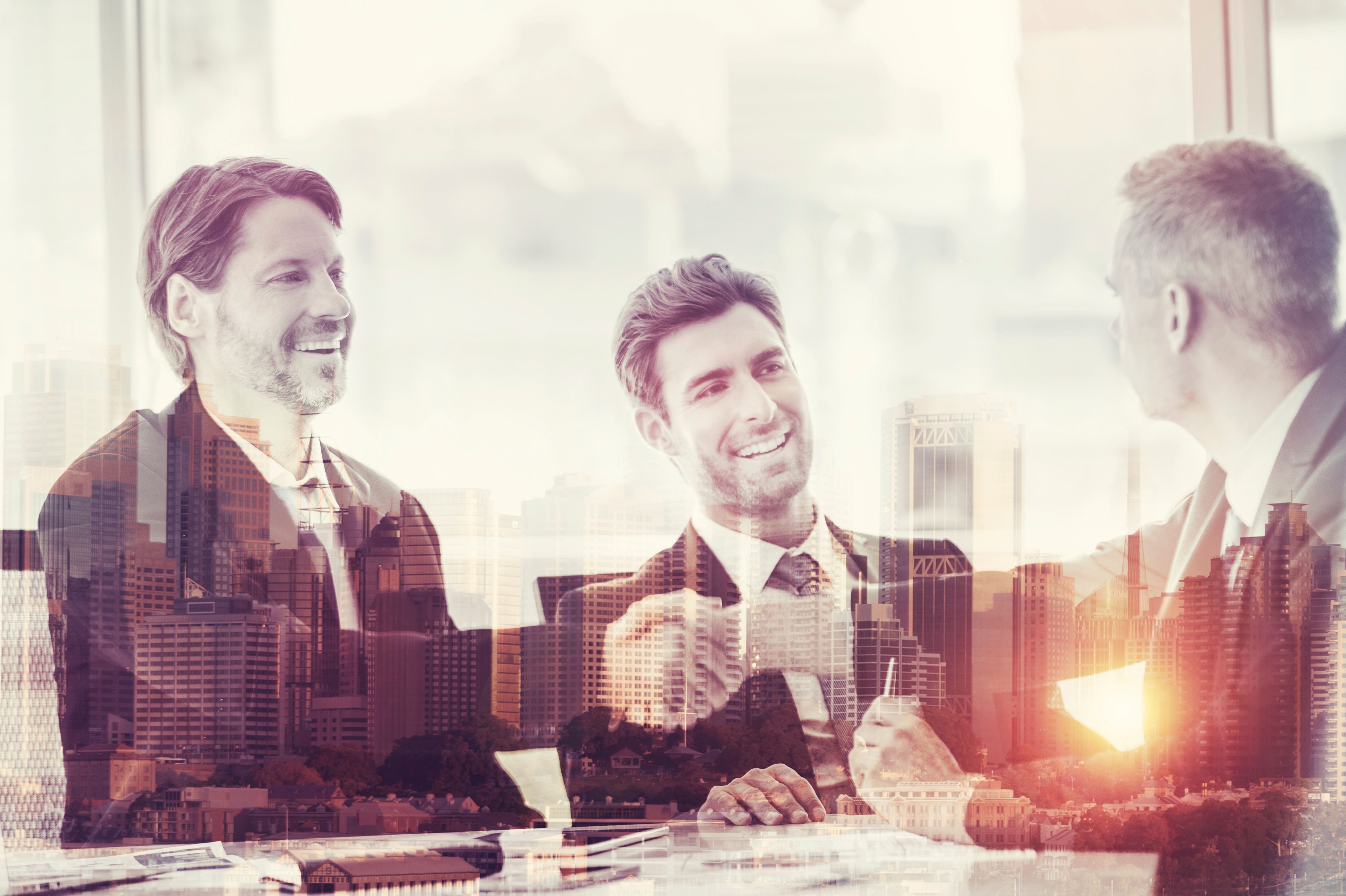 Montage of a team of business people working  at the boardroom table.
