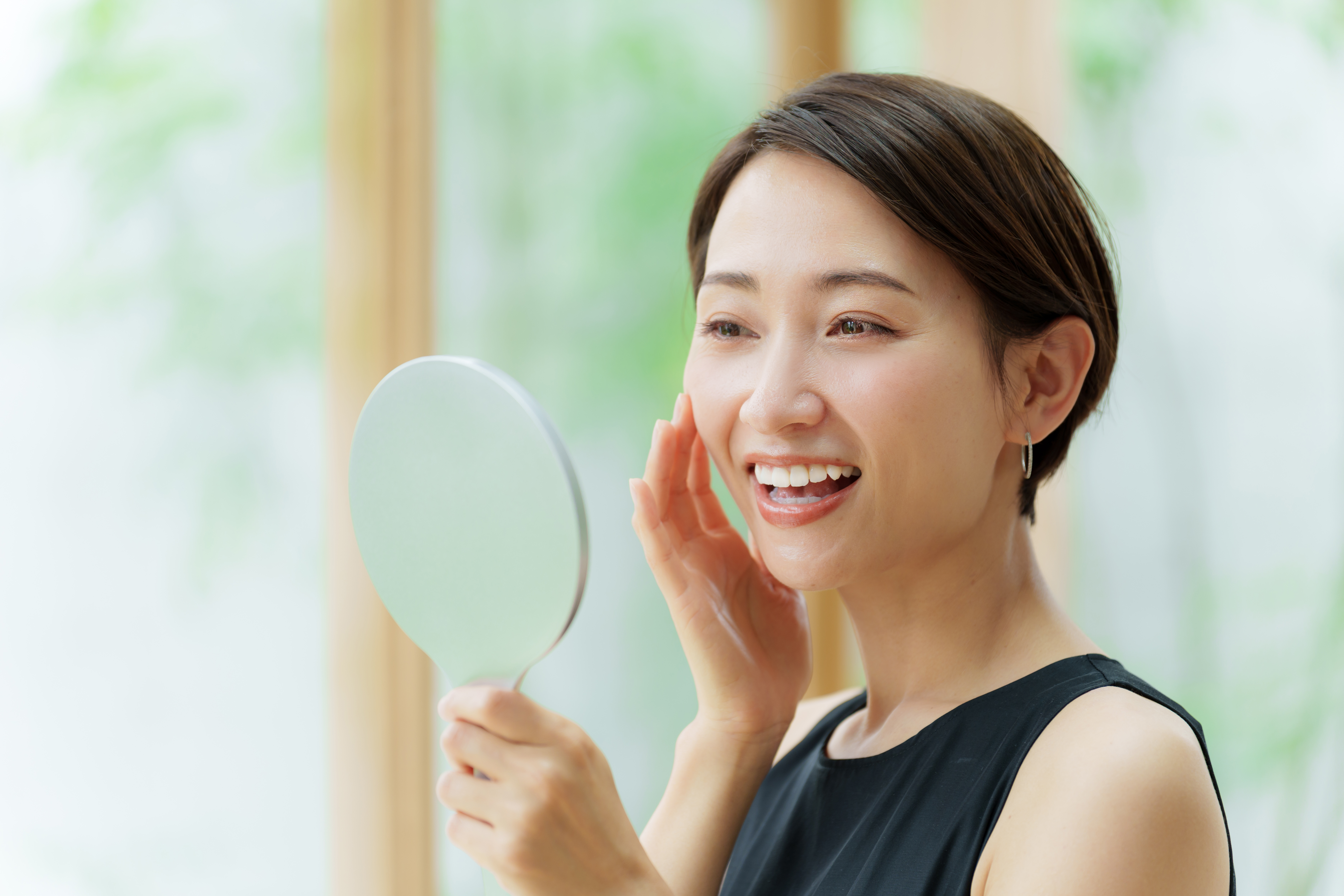 attractive asian woman wearing black dress looking mirror attractive asian woman wearing black dress looking mirror