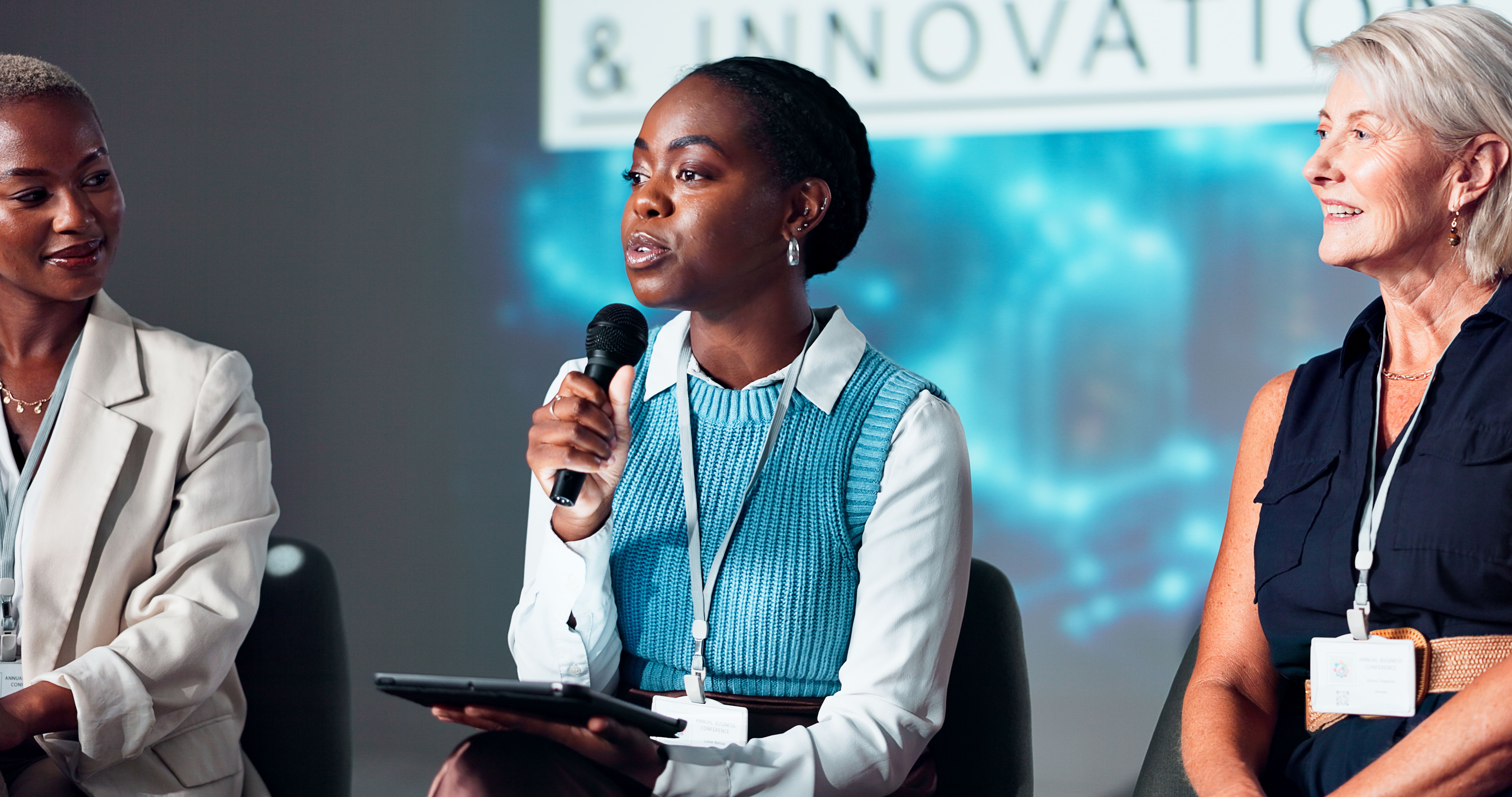 Woman, speaker and tablet with mic at seminar for presentation or innovation at workshop. Group, employees or spokesperson with technology for speech, tech campaign or future development at workplace