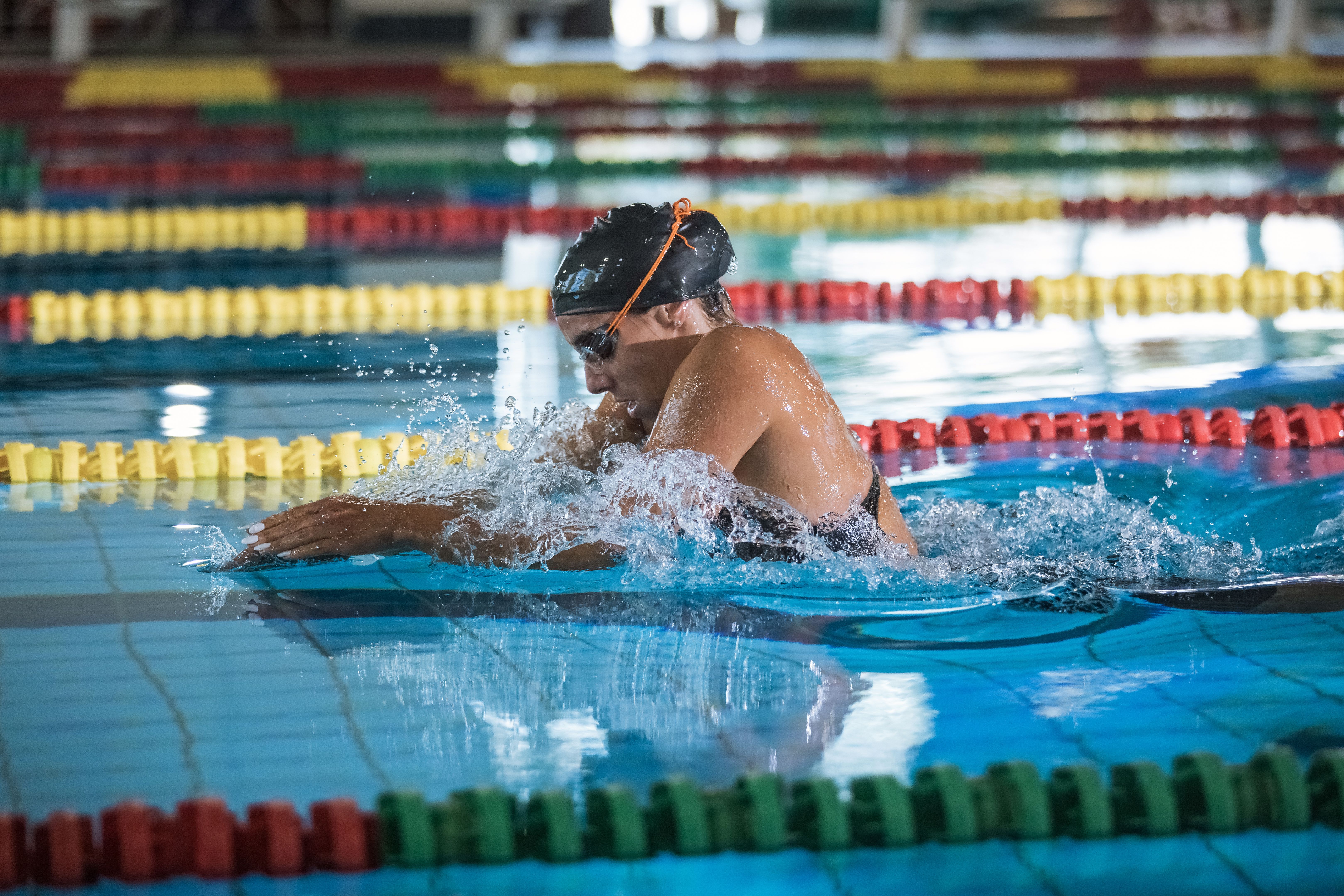 Powerful female swimmer swimming breaststroke at speed Powerful female swimmer swimming breaststroke at speed