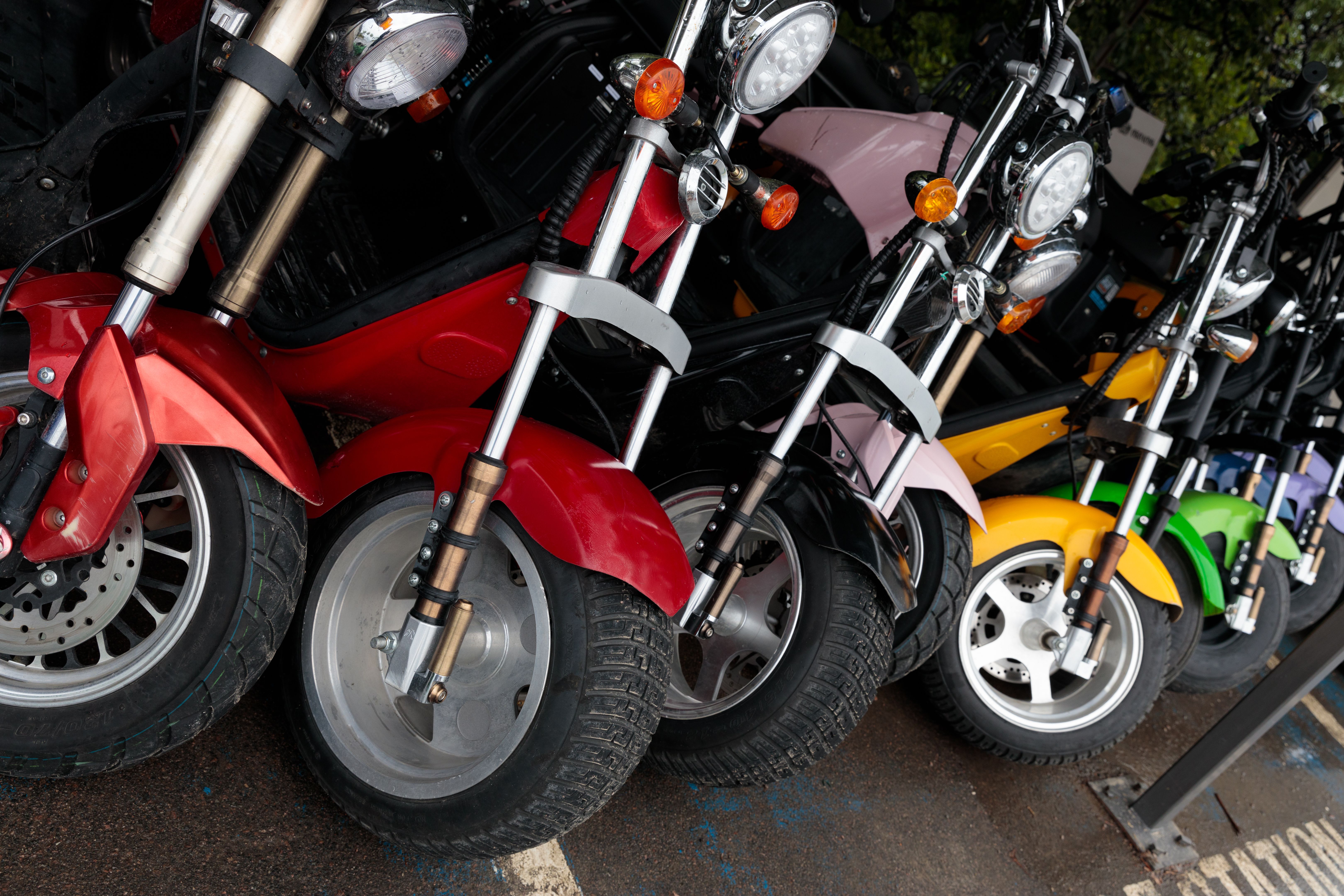 Colorful Collection of Compact Motorcycles Displayed in a Row Featuring Various Designs, Styles, and Vibrant Colors for Enthusiasts and Riders to Enjoy and Appreciate.