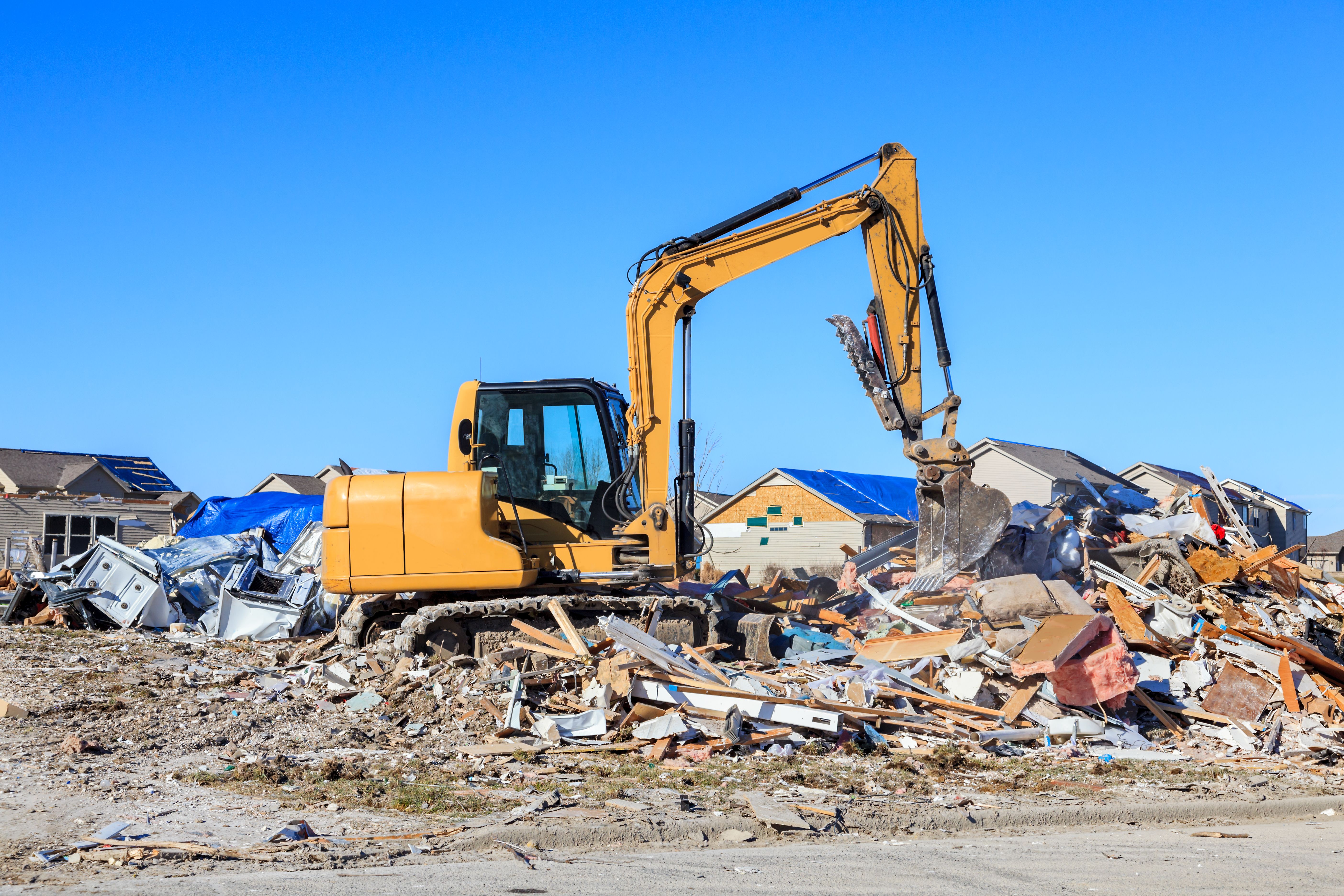 Backhoe cleaning up tornado damage