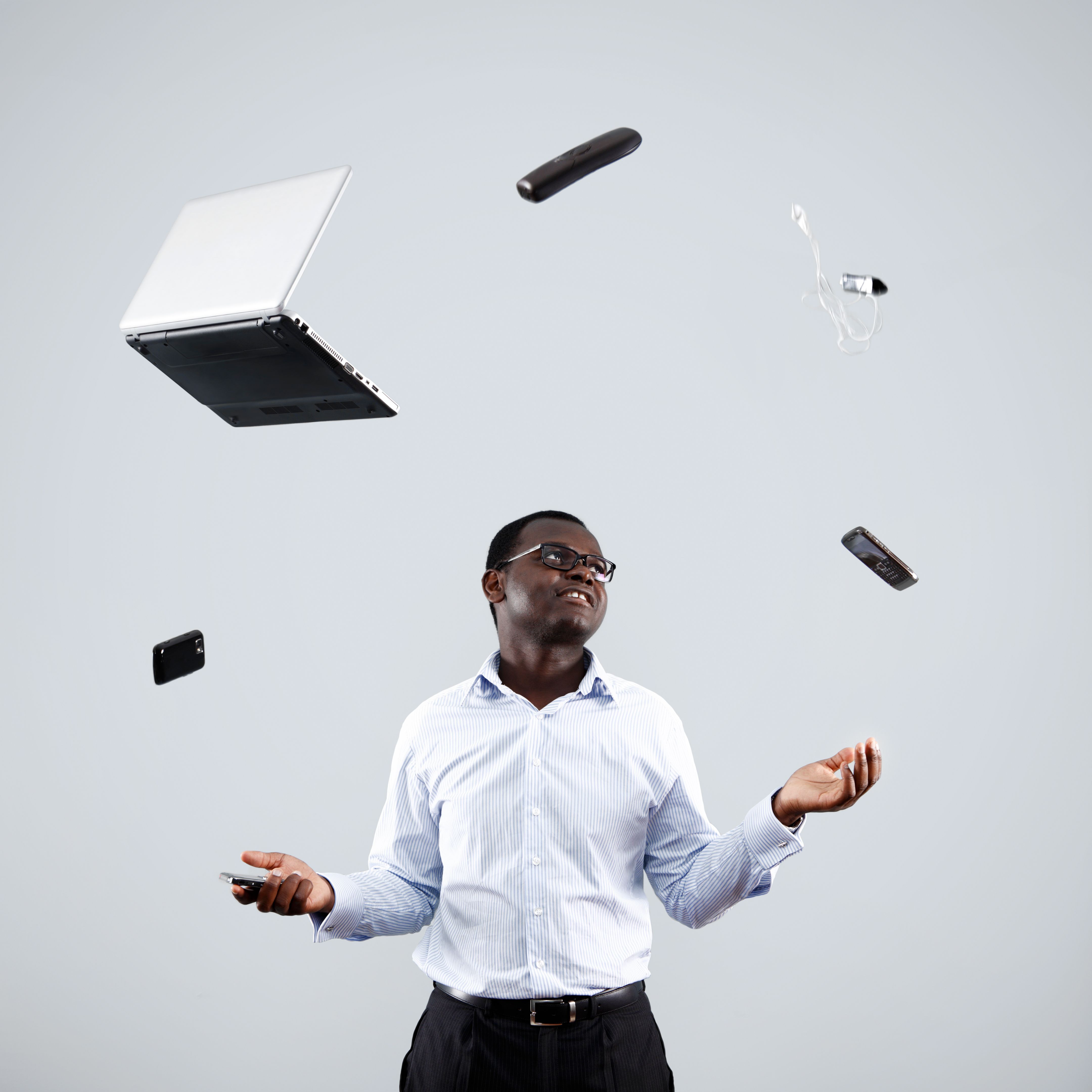 Businessman Juggling Technology
