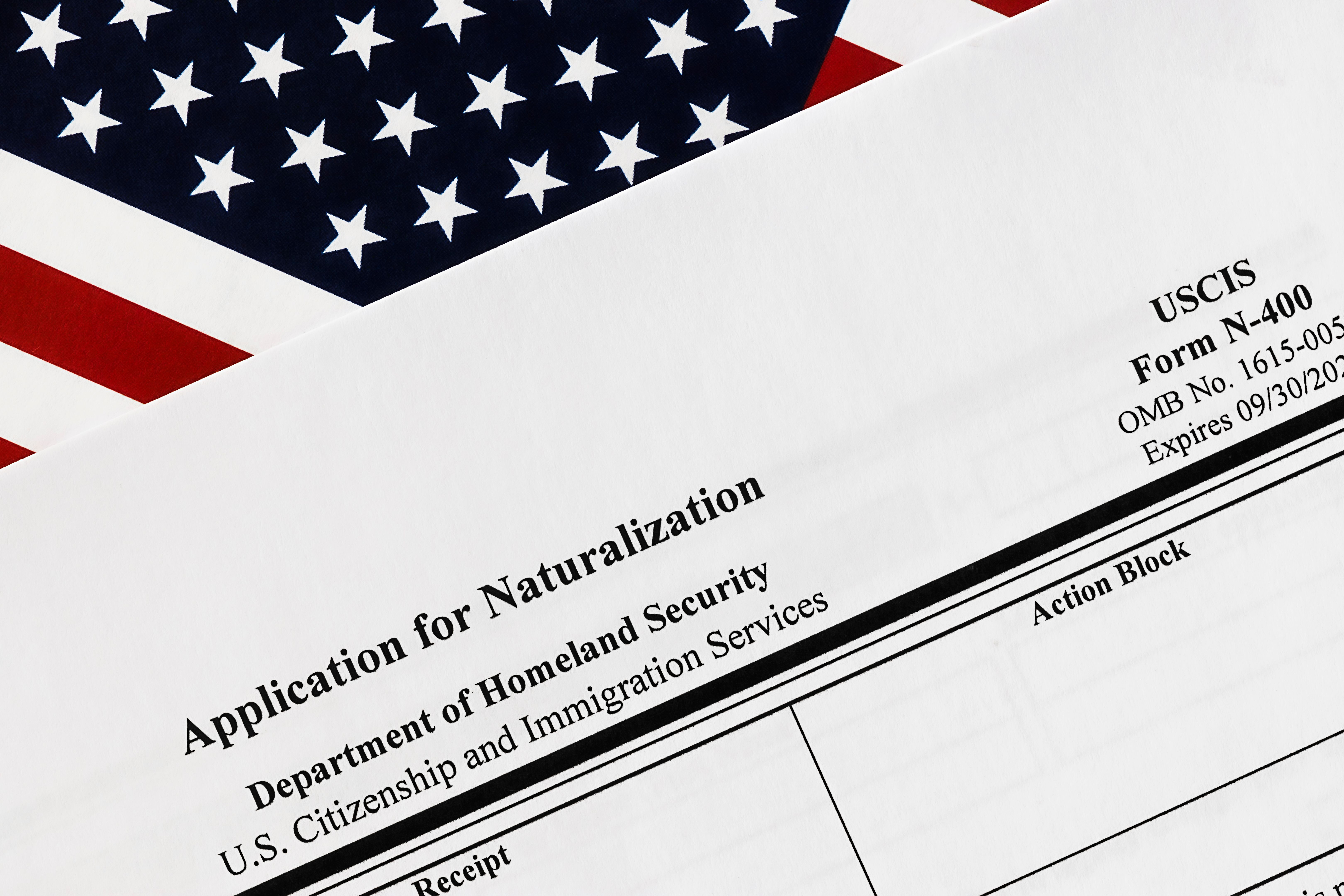 close-up of n-400 form. application for naturalization topview, on a background of United States flag.