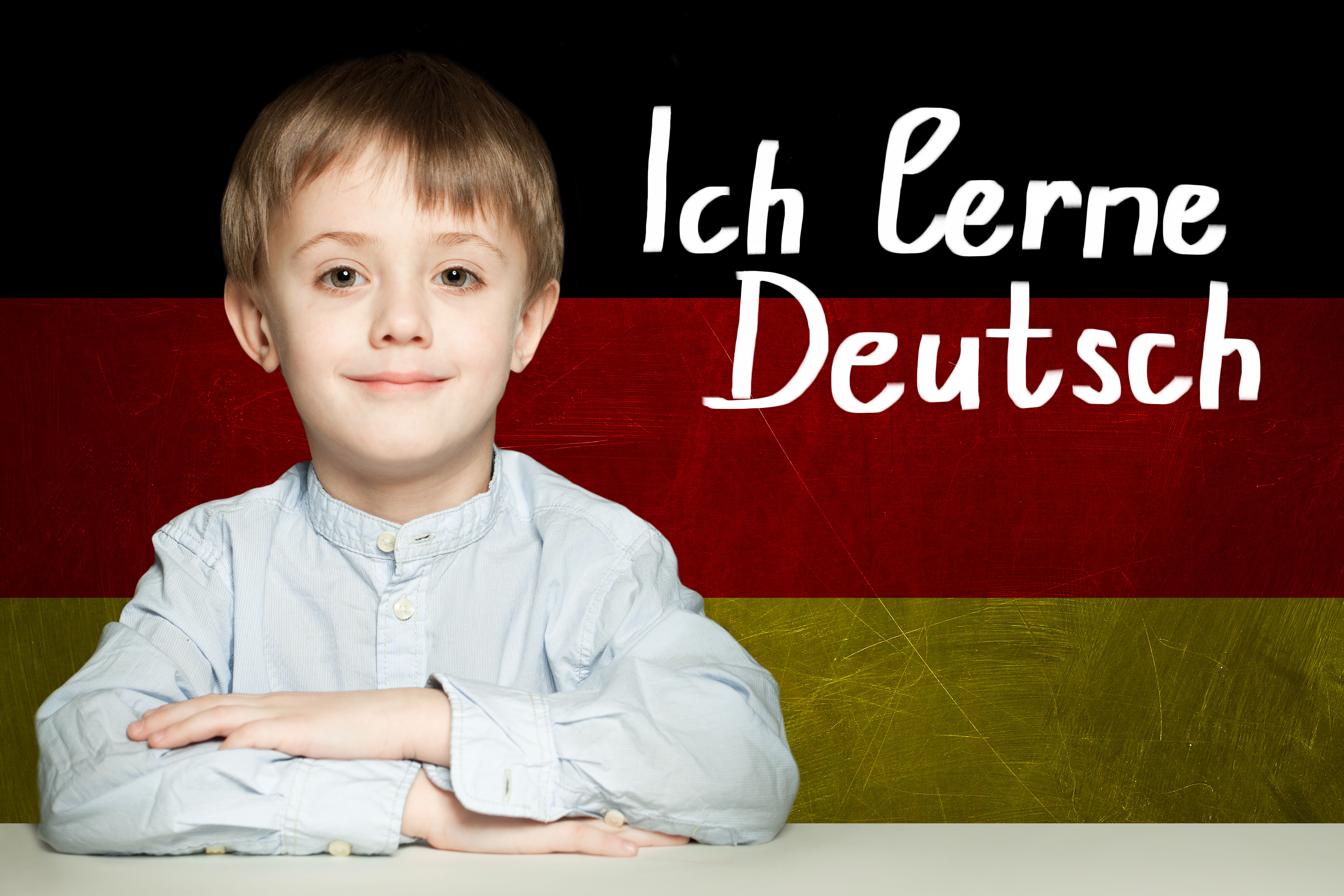 Thinking child boy student against the Germany flag background. Deutsch concept Thinking child boy student against the Germany flag background. Deutsch concept