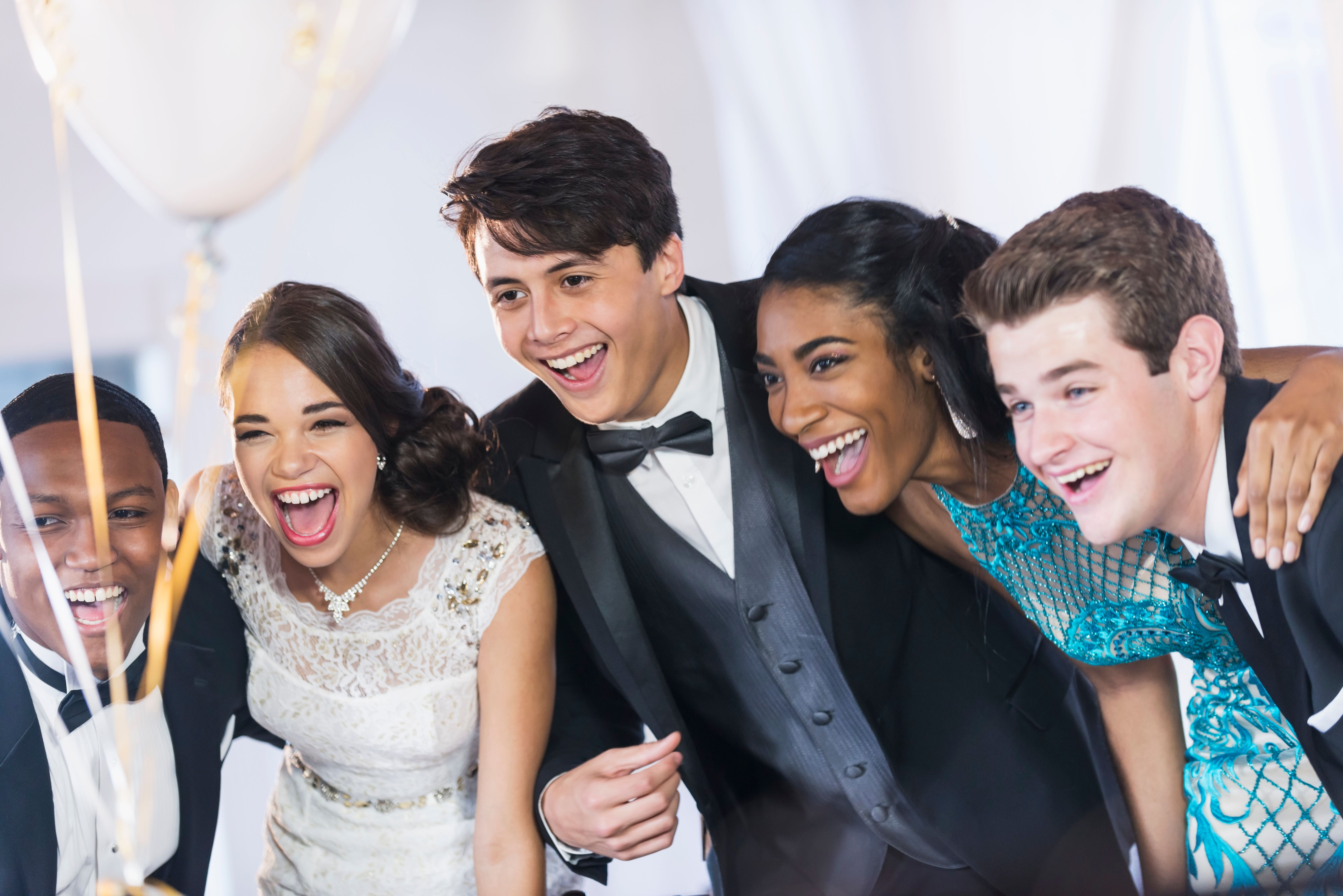Group of tgers at party wearing gowns and tuxedoseena