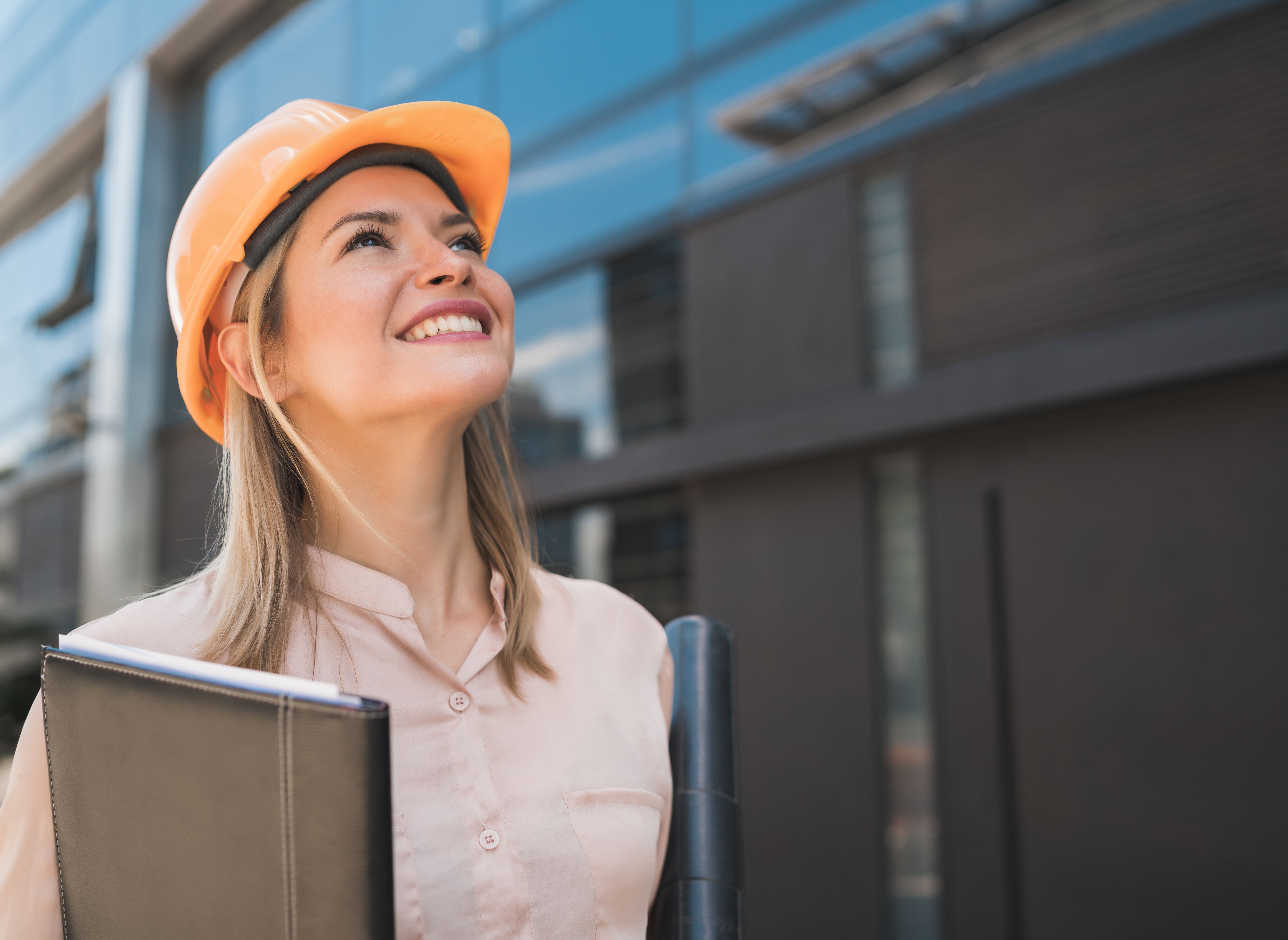 Professional architect woman standing outdoors. Professional architect woman standing outdoors.