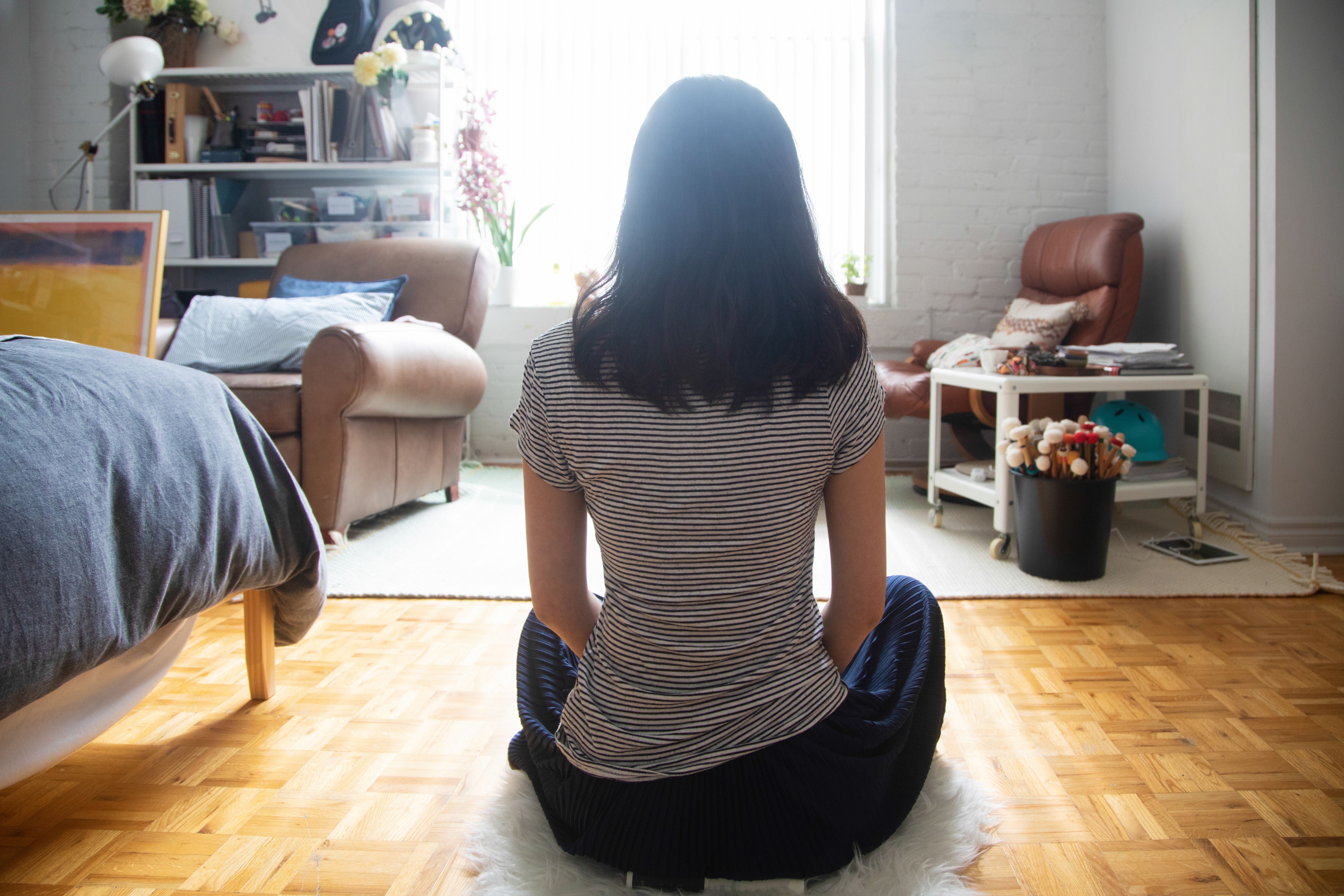 person meditating at home