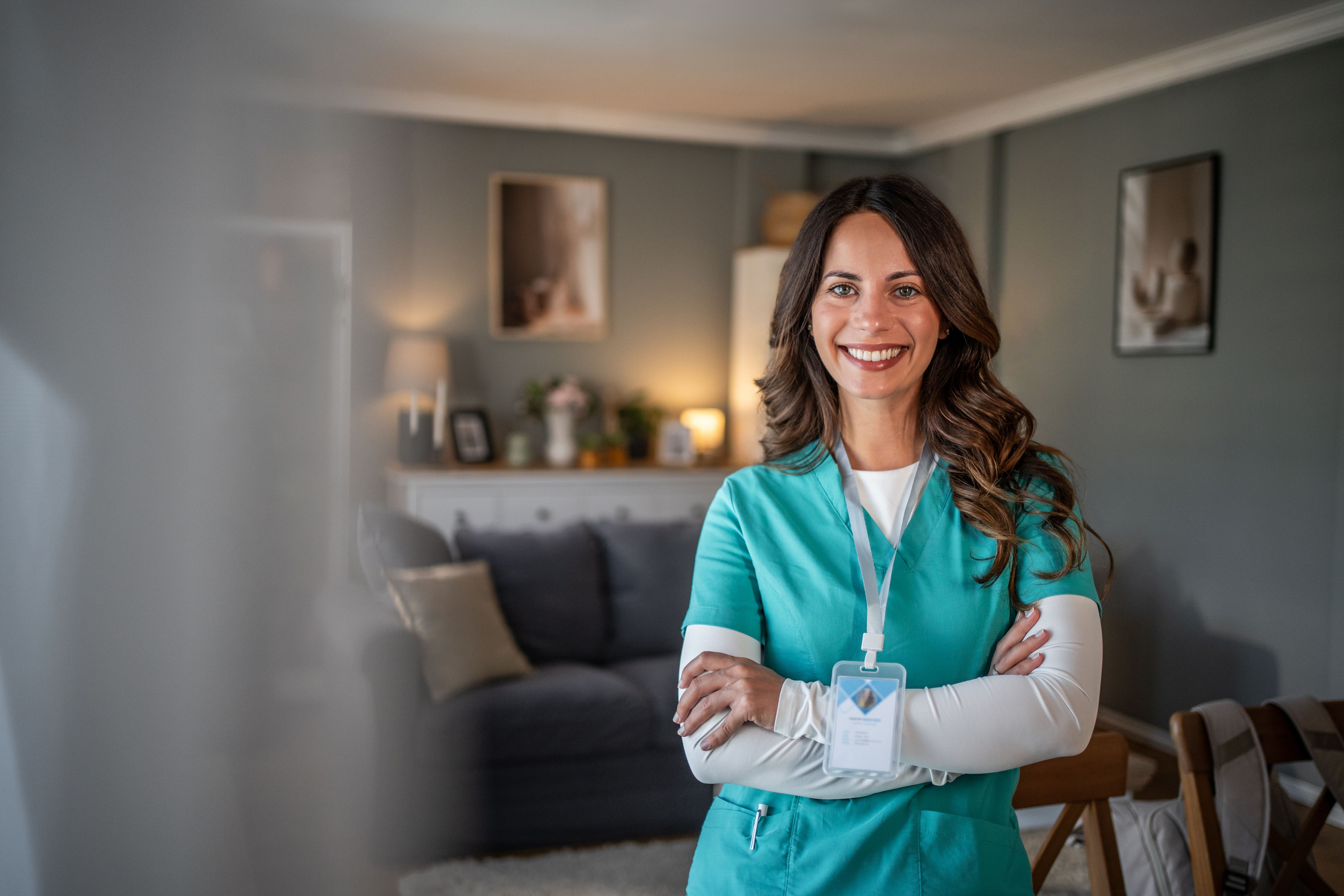 Smiling female nurse or caregiver at home