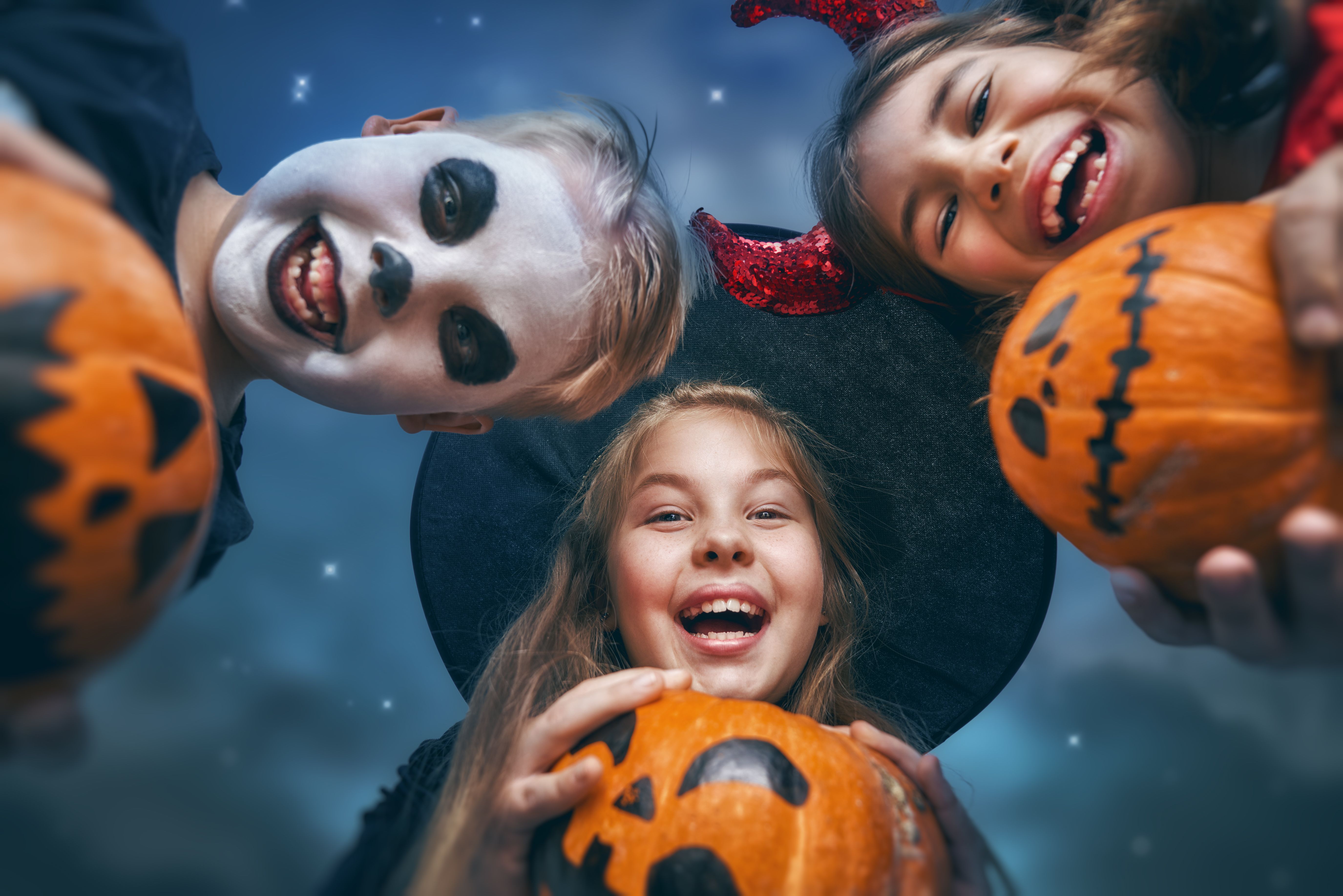 Laughing children in witches costumes. Laughing children in witches costumes.