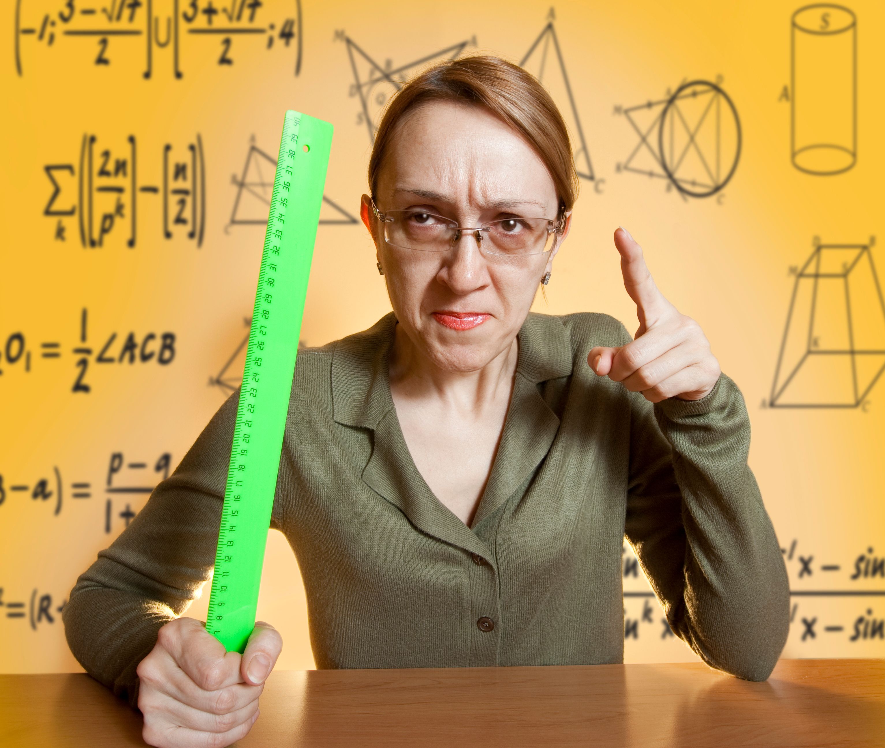 Mean female teacher holding ruler and pointing her finger