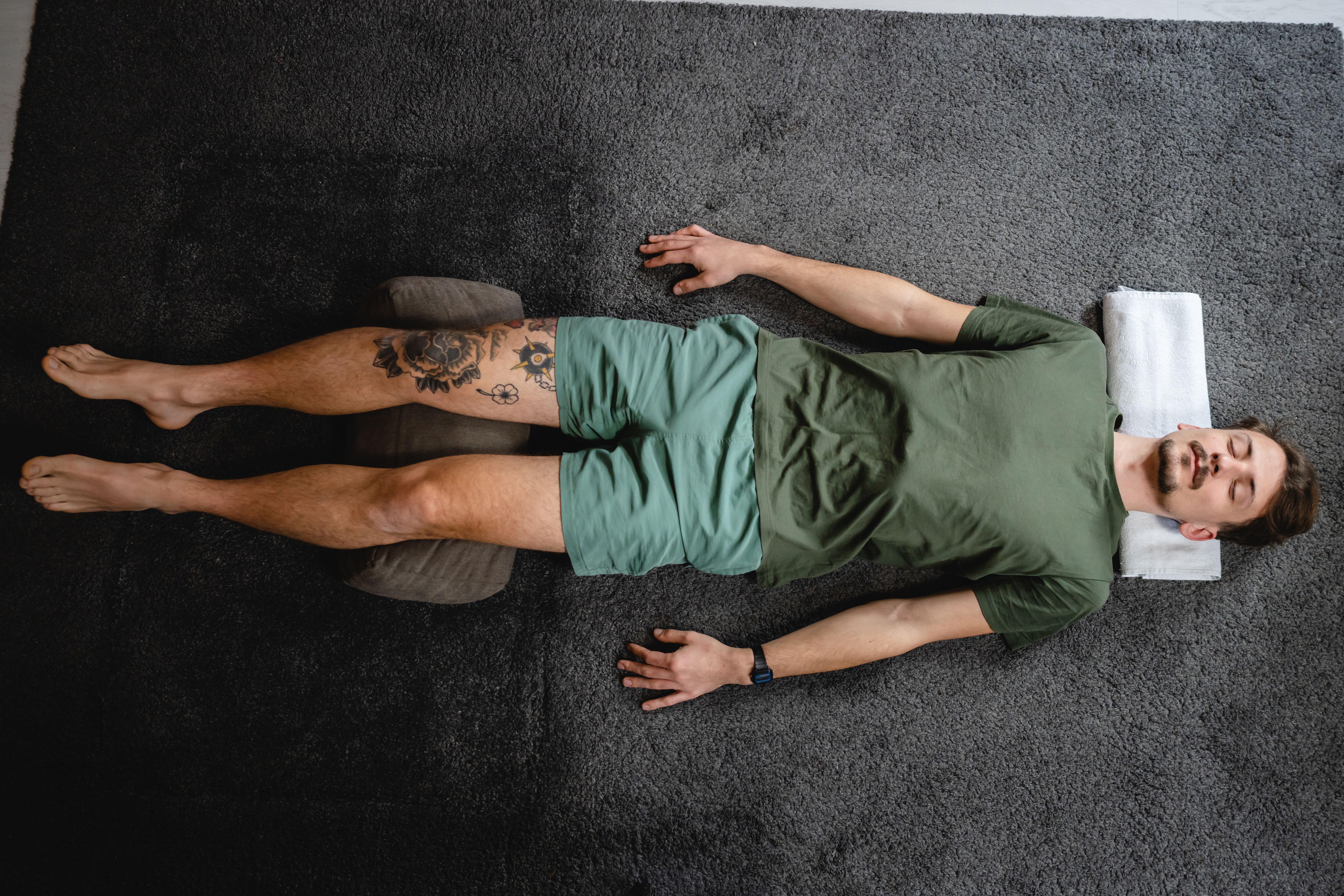 One modern caucasian man adult male practice restorative yoga at home One modern caucasian man adult male practice restorative yoga at home