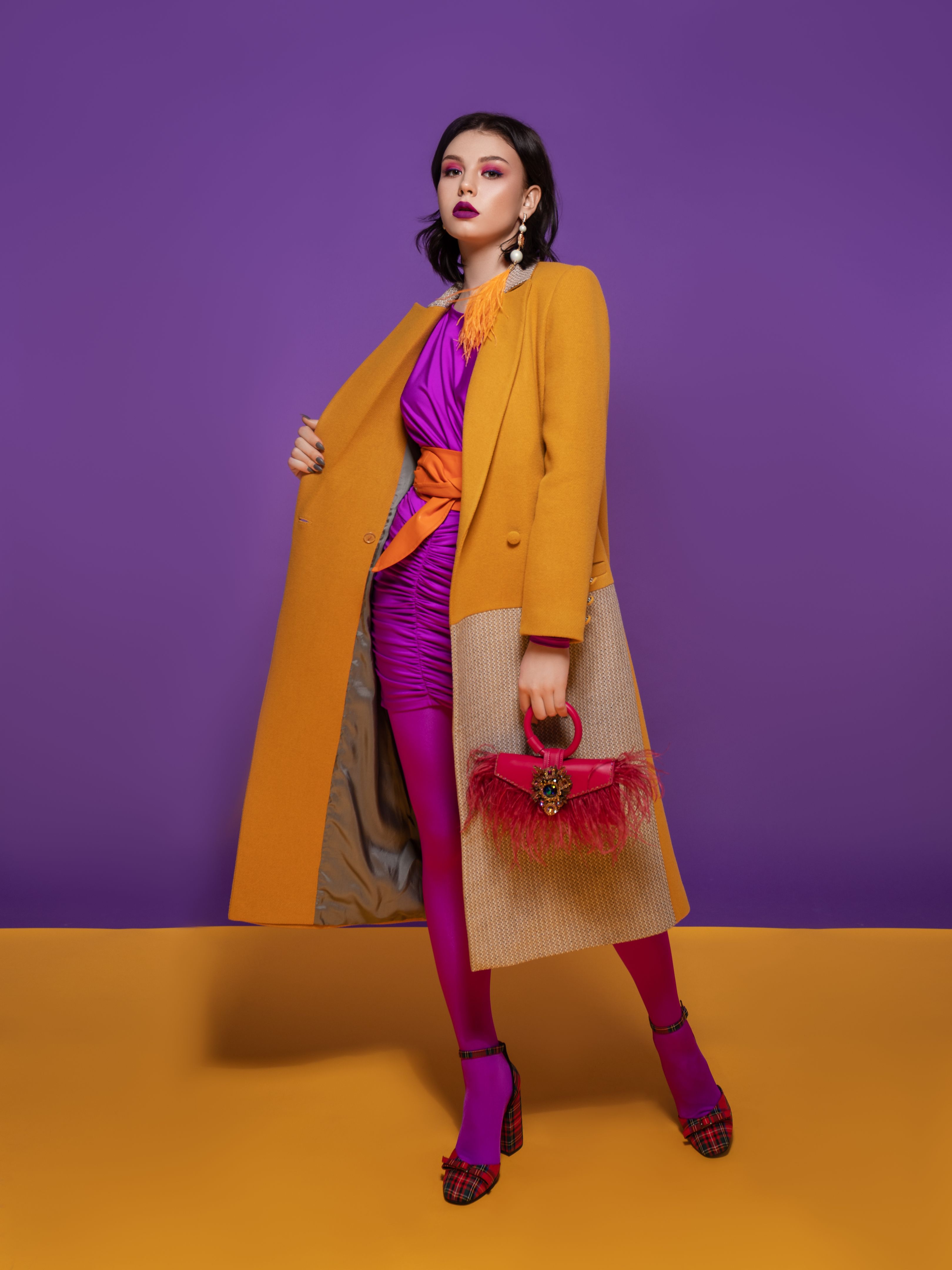 Fashion model on yellow and purple studio background