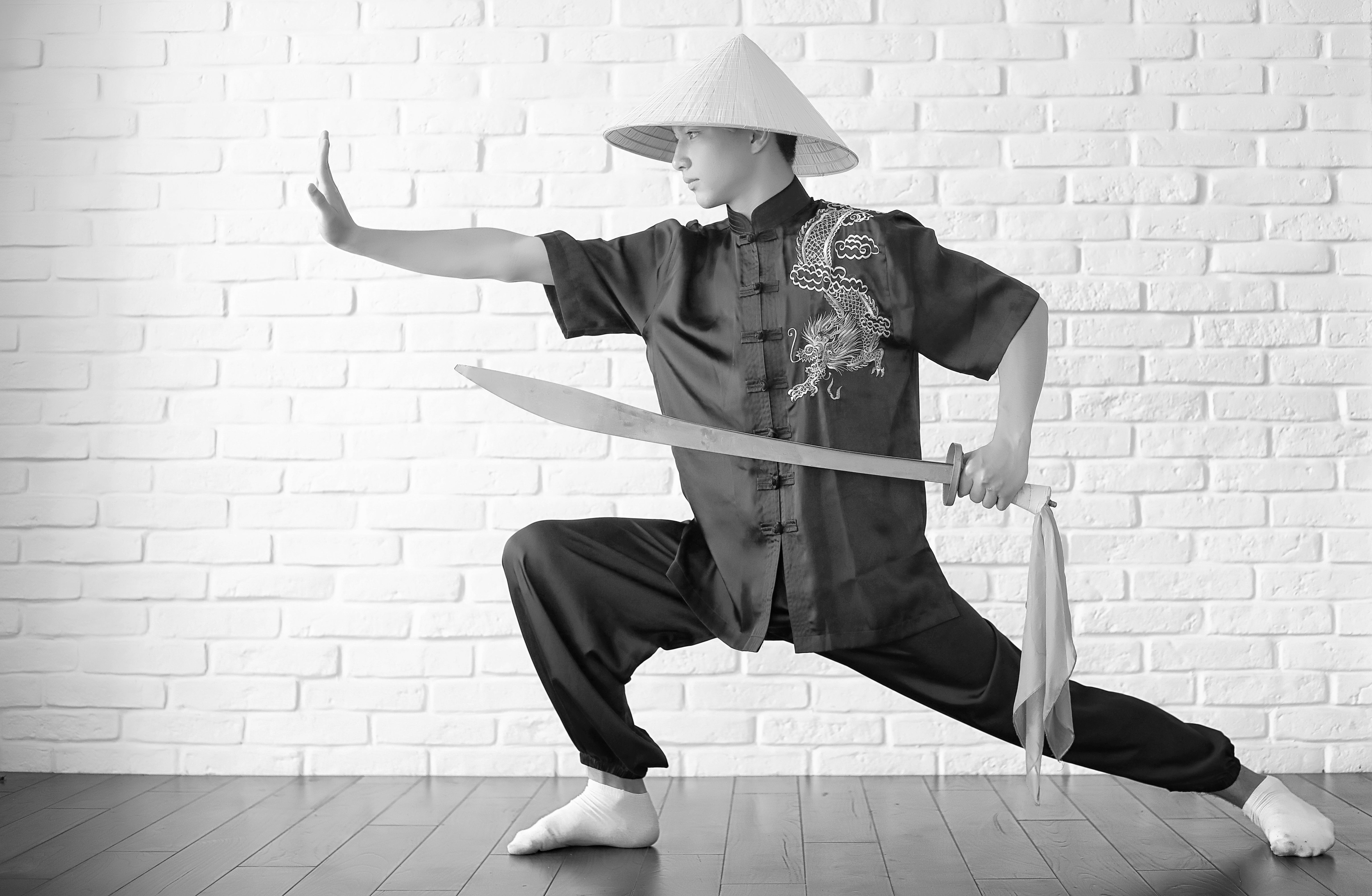 Asian novice on a white brick wall