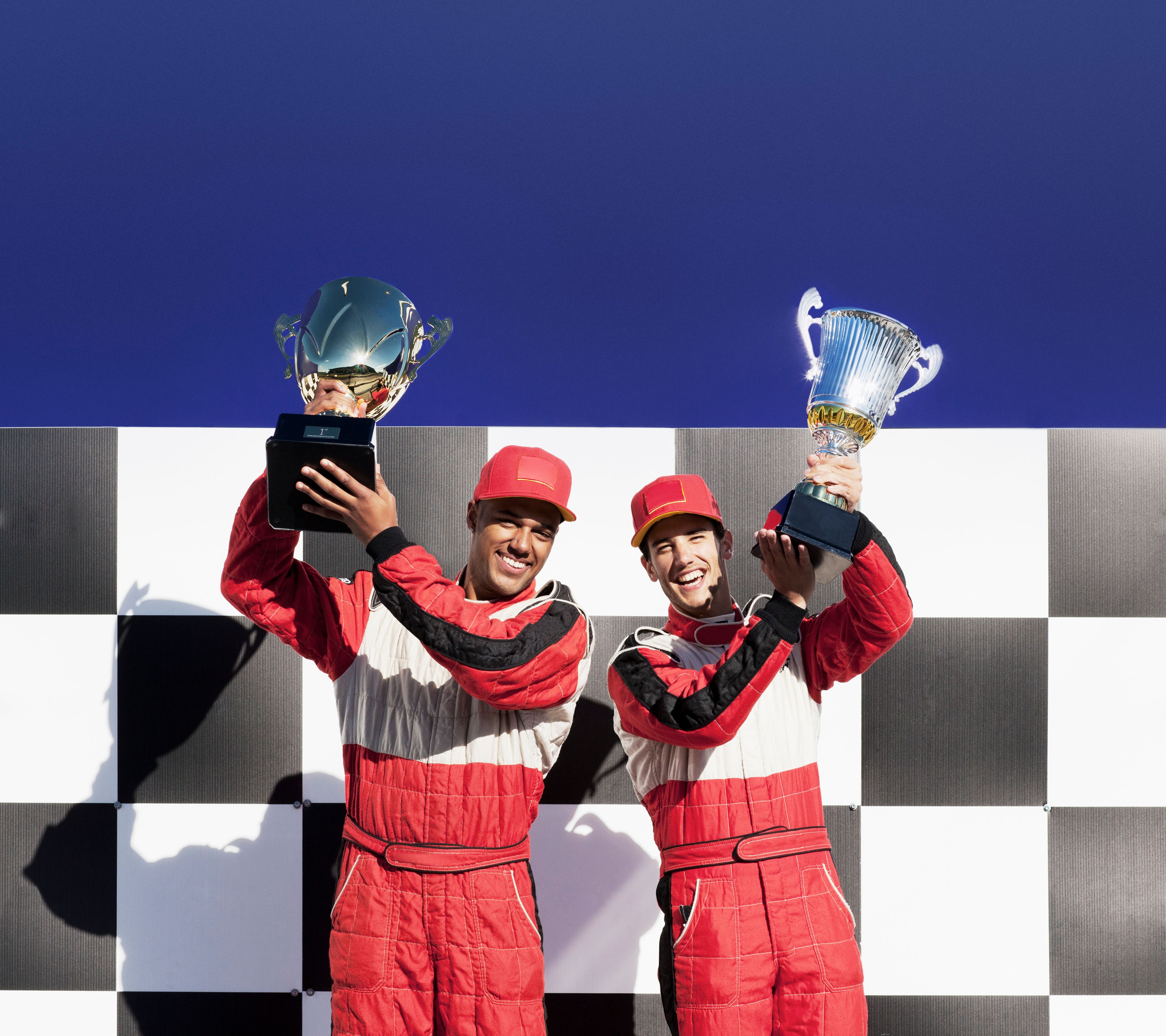 Racers holding trophies at award ceremony