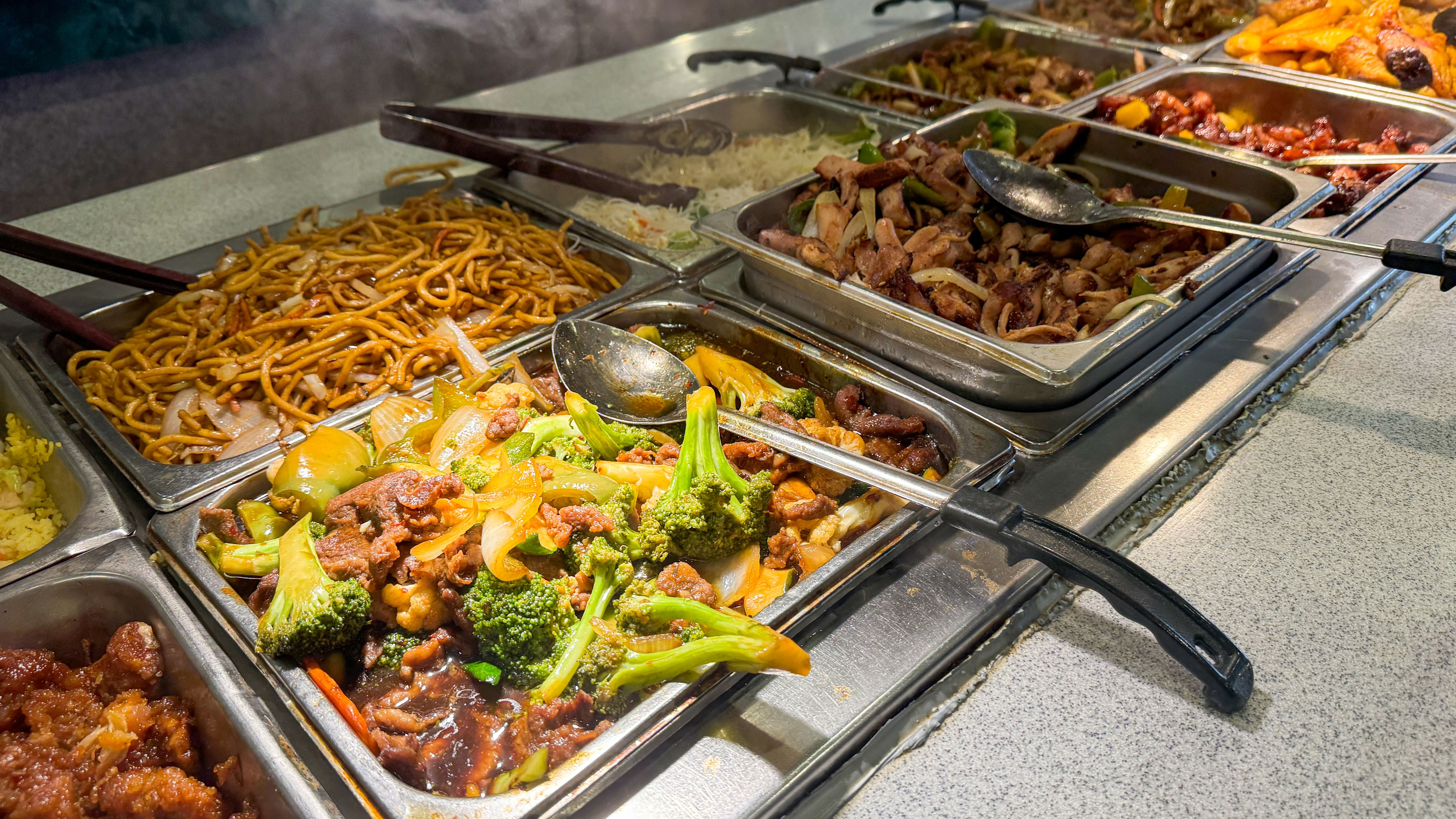 various Asian dishes, including stir-fried noodles, beef and broccoli, and mixed vegetables various Asian dishes, including stir-fried noodles, beef and broccoli, and mixed vegetables