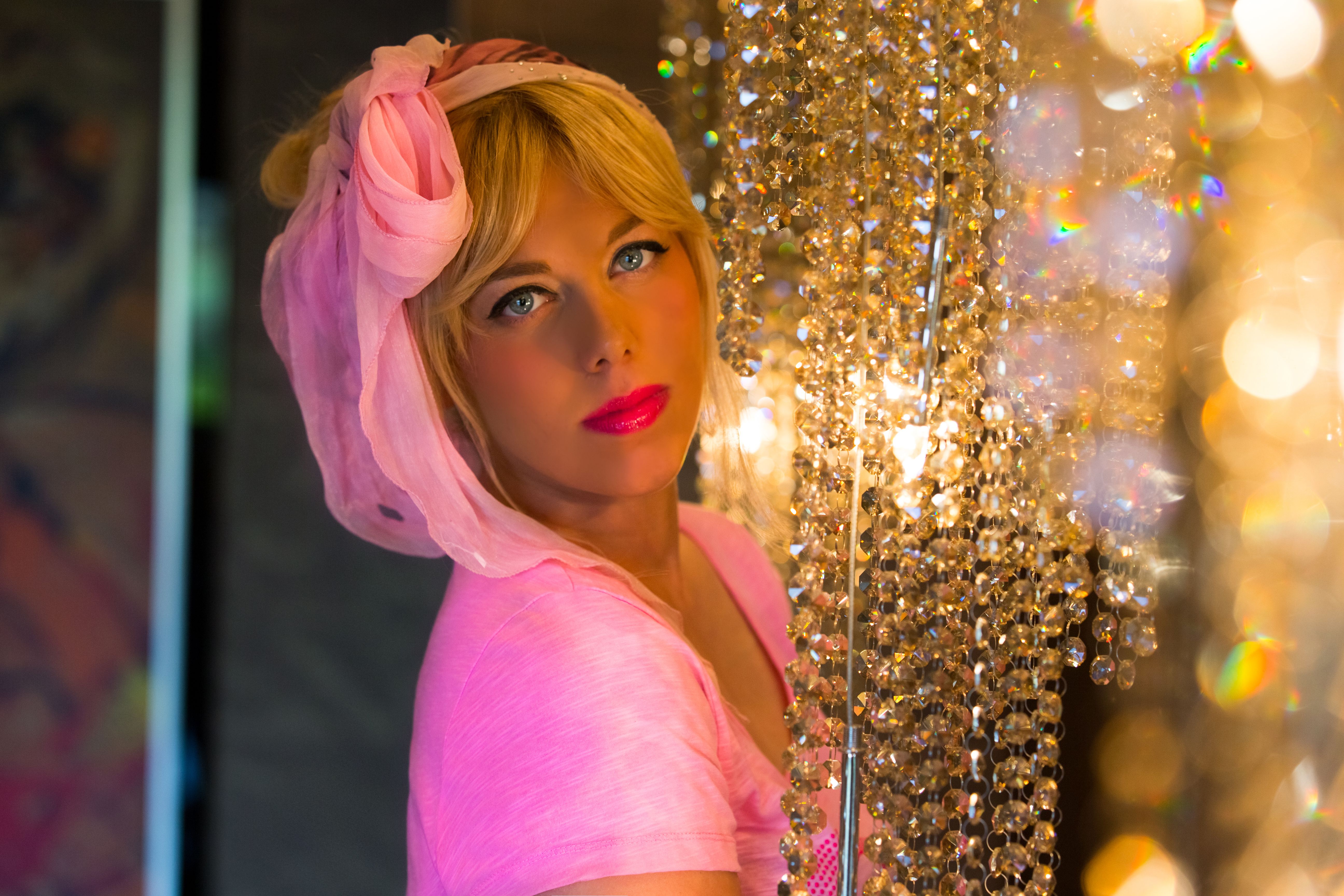 Blonde woman beside crystal curtain