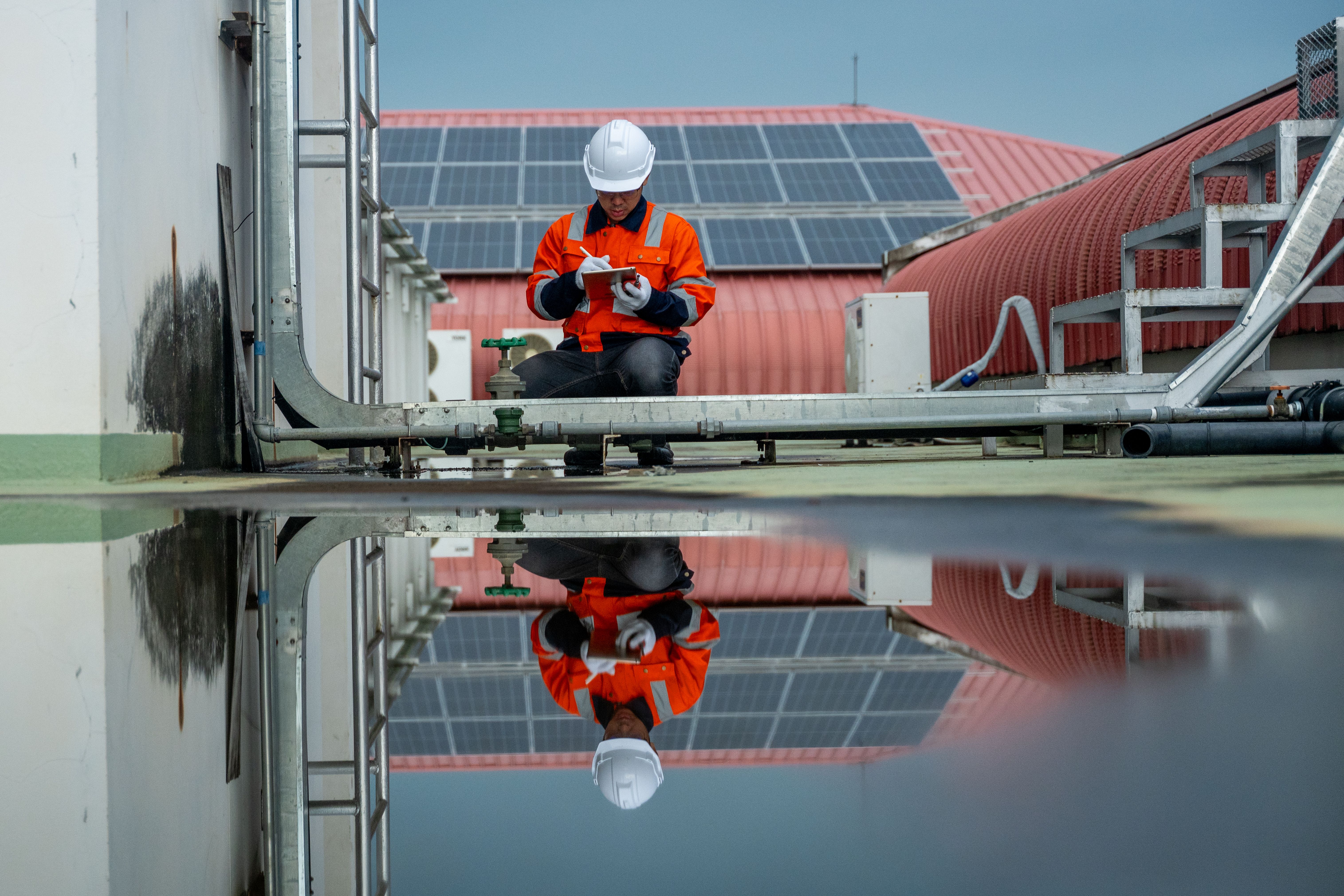 technician inspecting solar panels