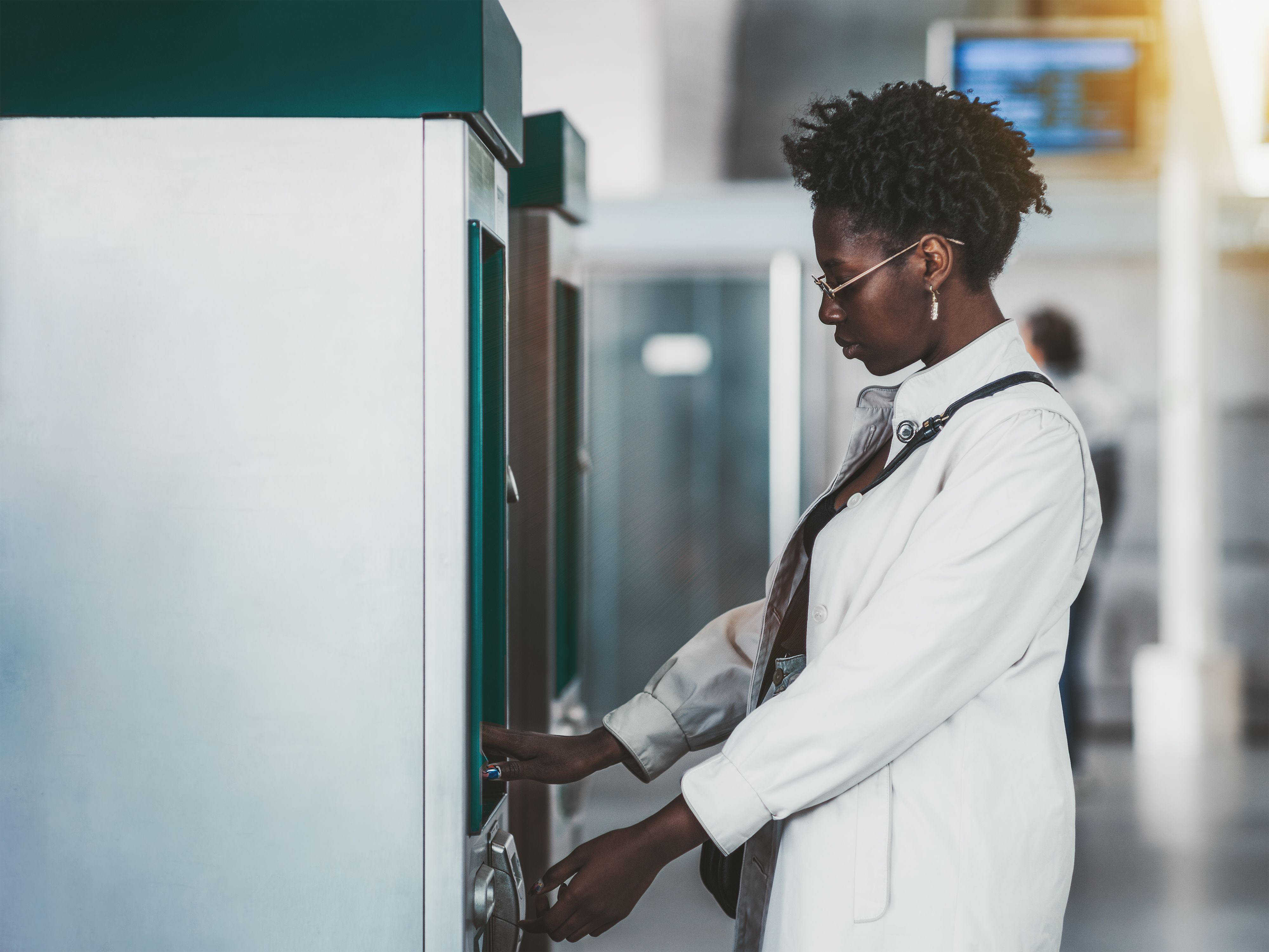 Black girl is using ATM