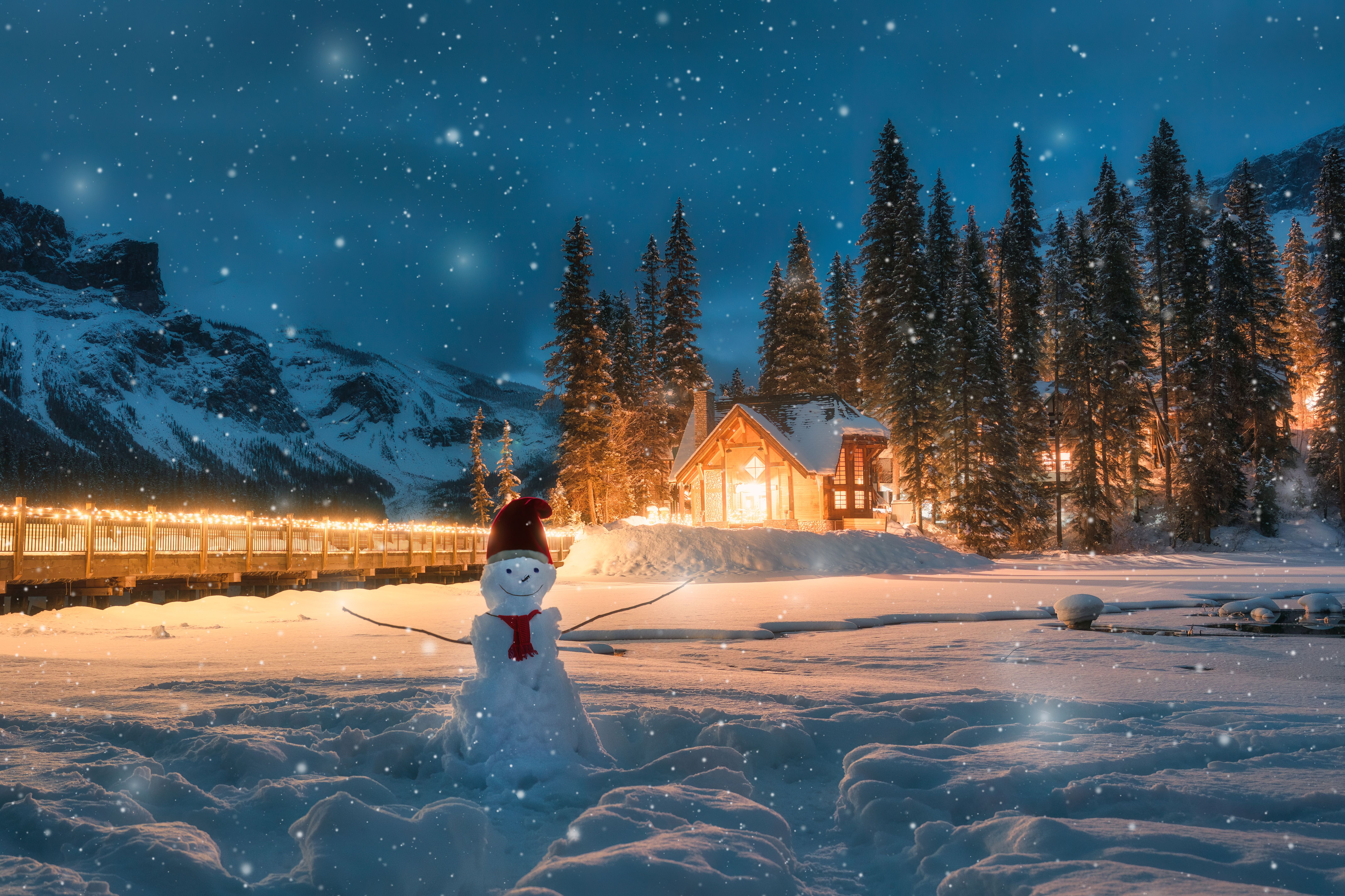 Emerald Lake with wooden cottage and snowman in falling snow at Yoho national park, Canada Emerald Lake with wooden cottage and snowman in falling snow at Yoho national park, Canada