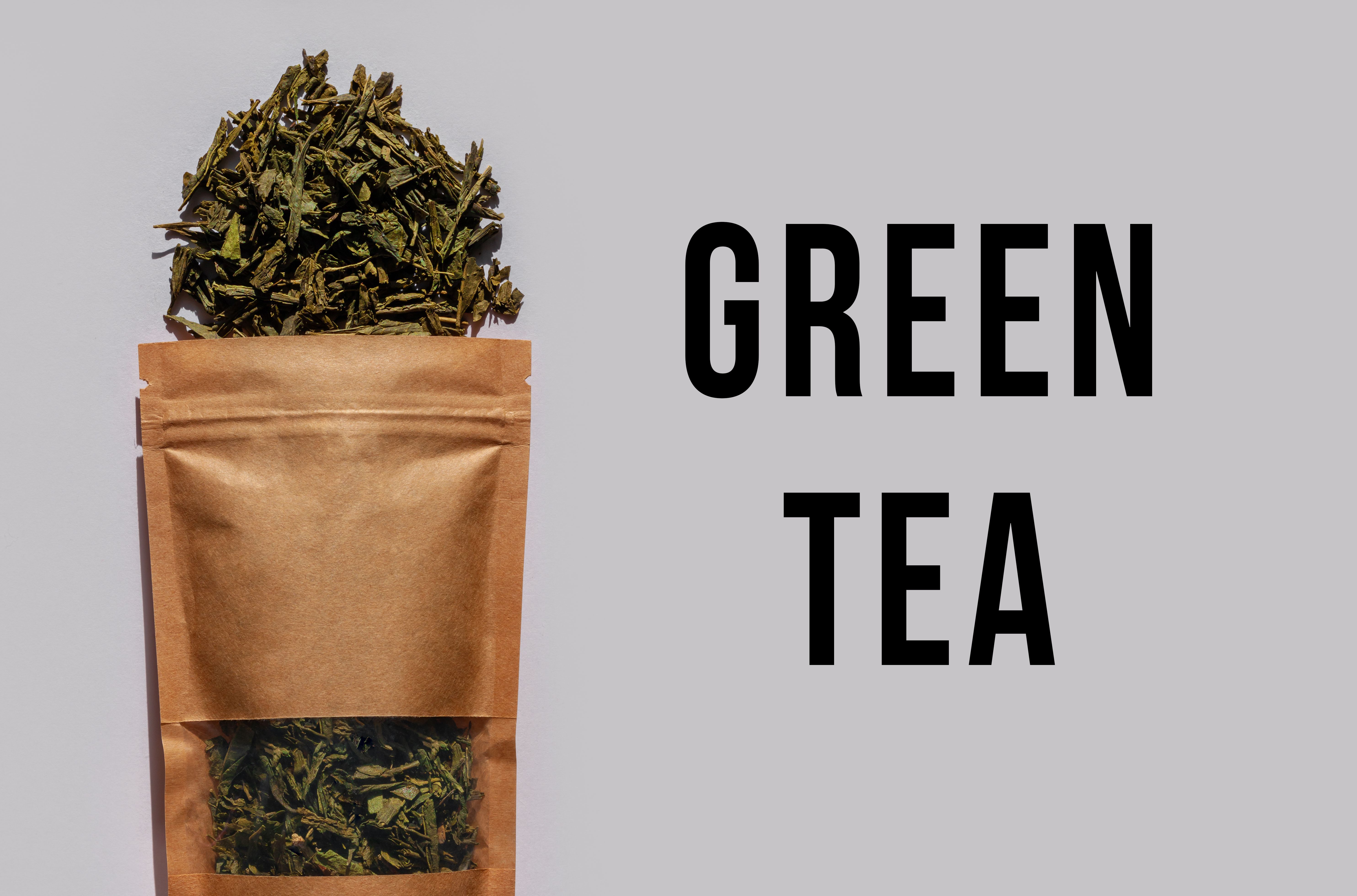 Brown kraft paper pouch bags with tea leaves top view with harsh shadow on white background. Coffee packaging flat lay.