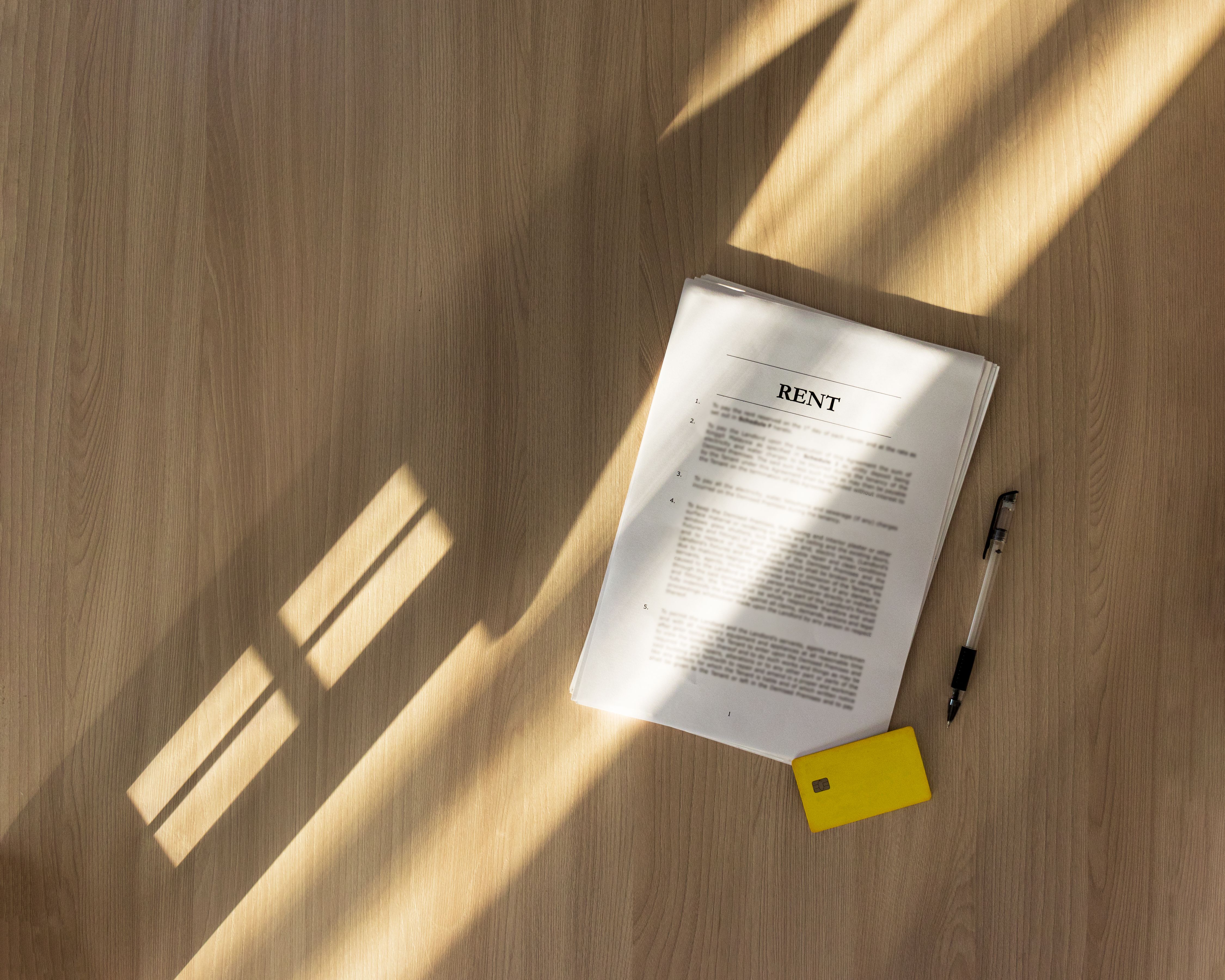 concept of renting a house or real estate when studying an office contract,Shadow in the form of a house on the table