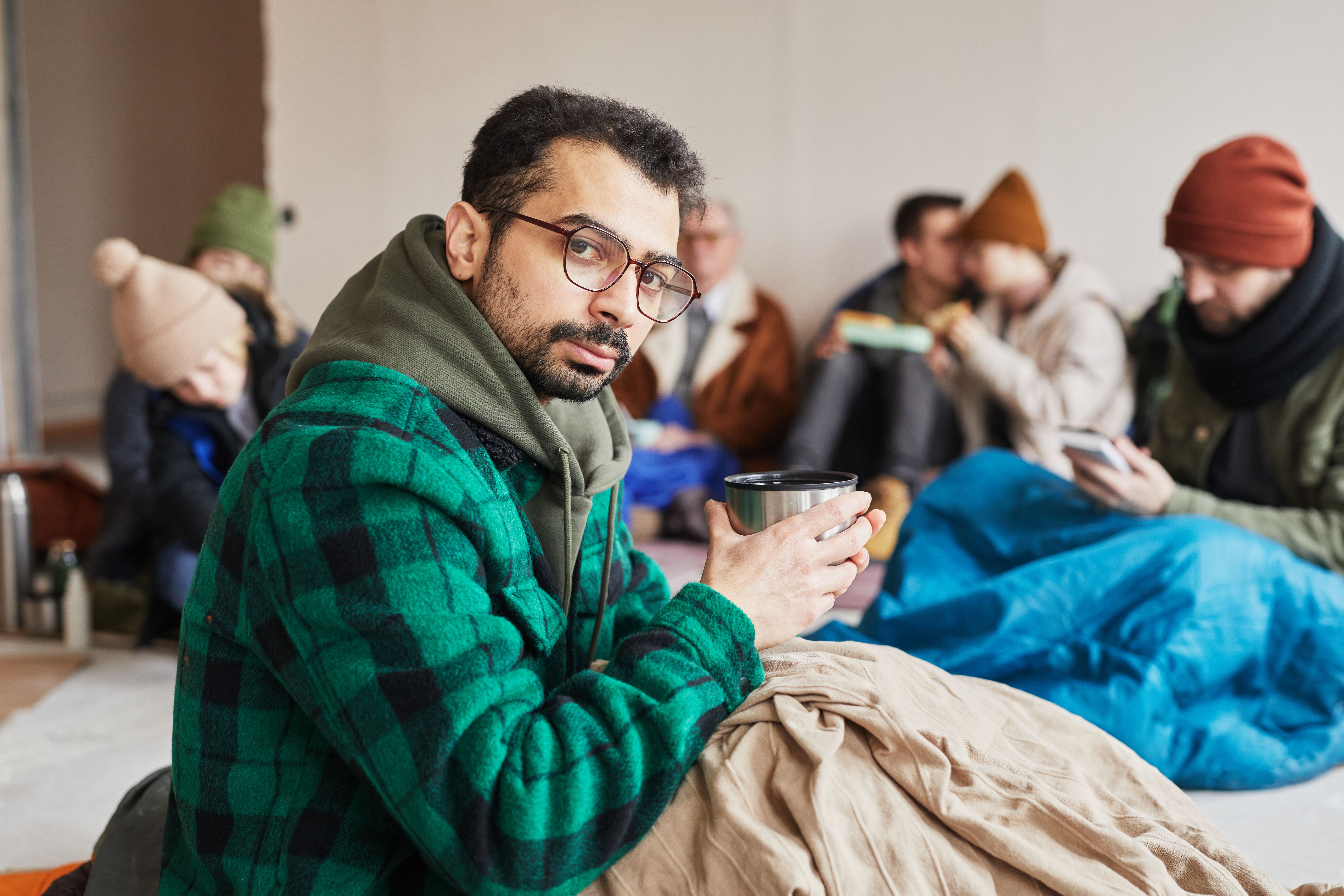 Portrait of Man with Hot Drink in Shelter