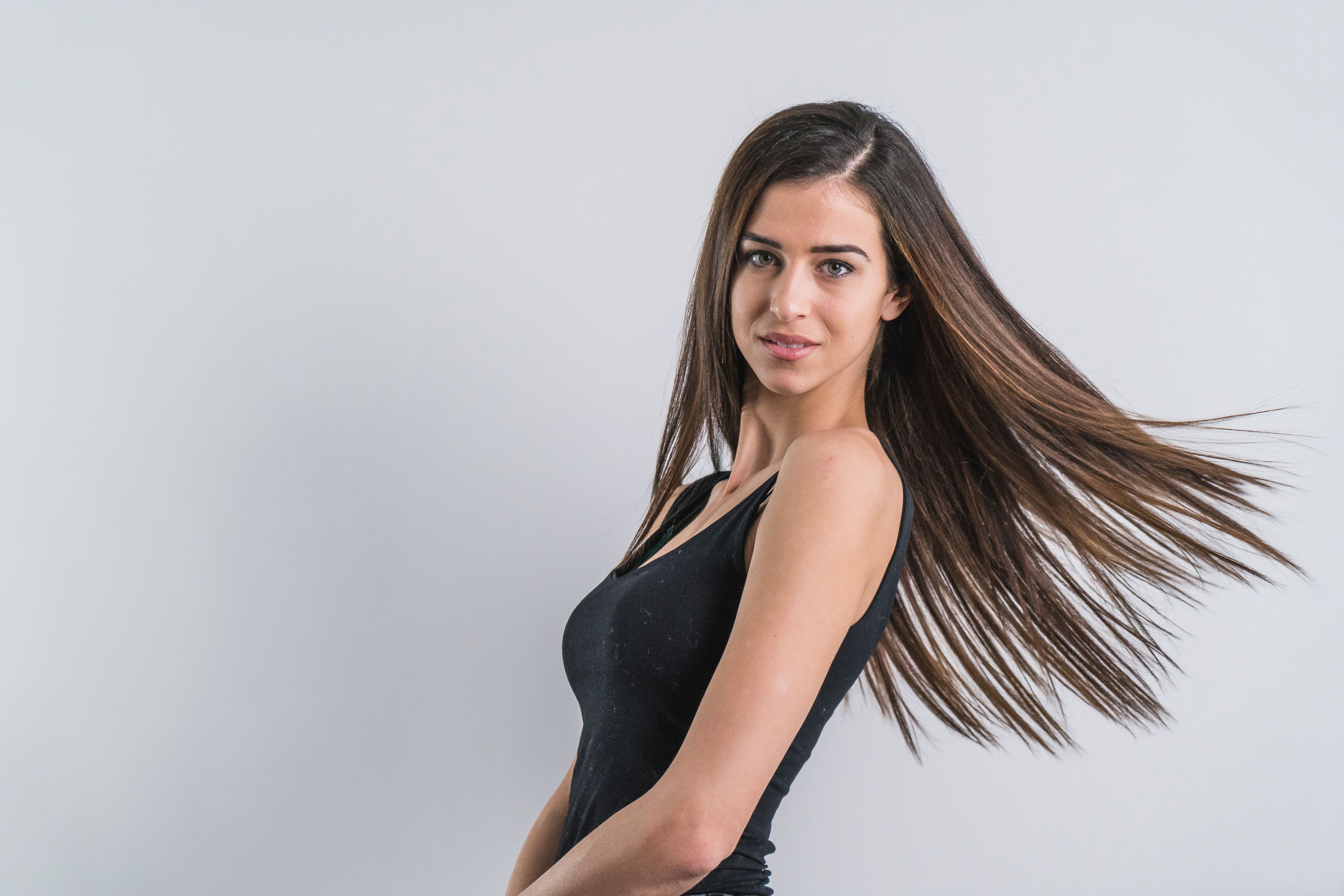 Pretty brunette in black top with her hair nicely waving