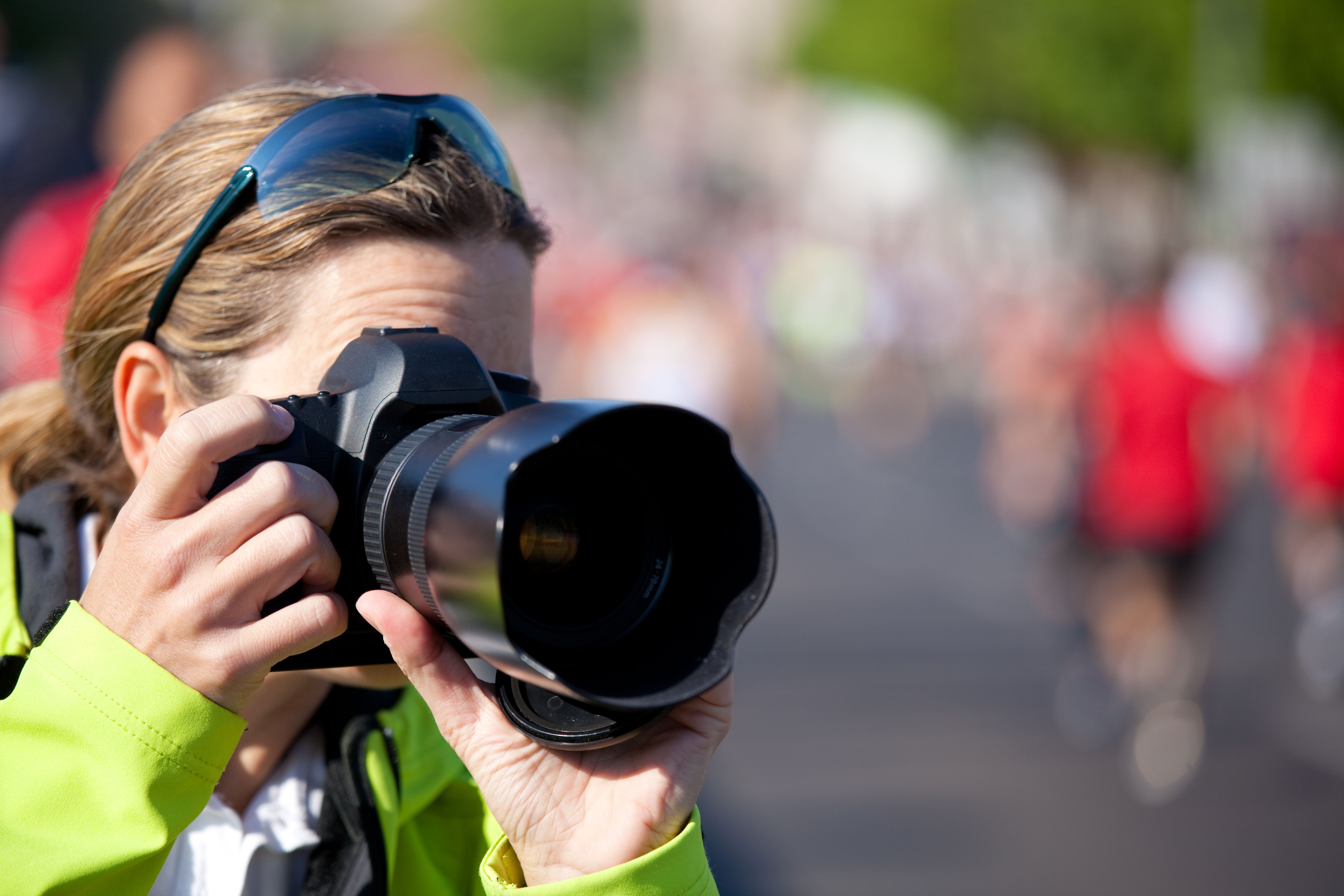 woman taking pictures of sports event